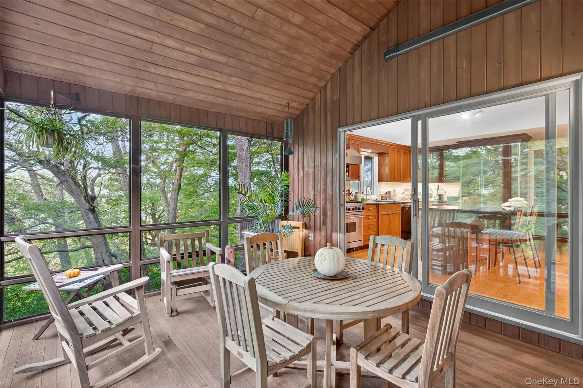 Screened-in porch with sliders, one into kitchen and the other into the dining room Screened-in porch with sliders, one into kitchen and the other into the dining room