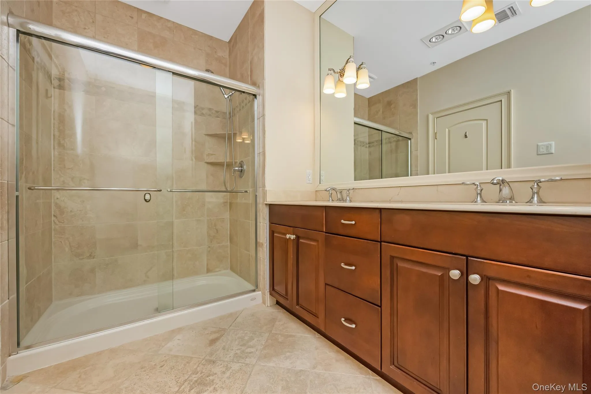 Primary bathroom with with 2 sinks, stall shower and large linen closet Primary bathroom with with 2 sinks, stall shower and large linen closet
