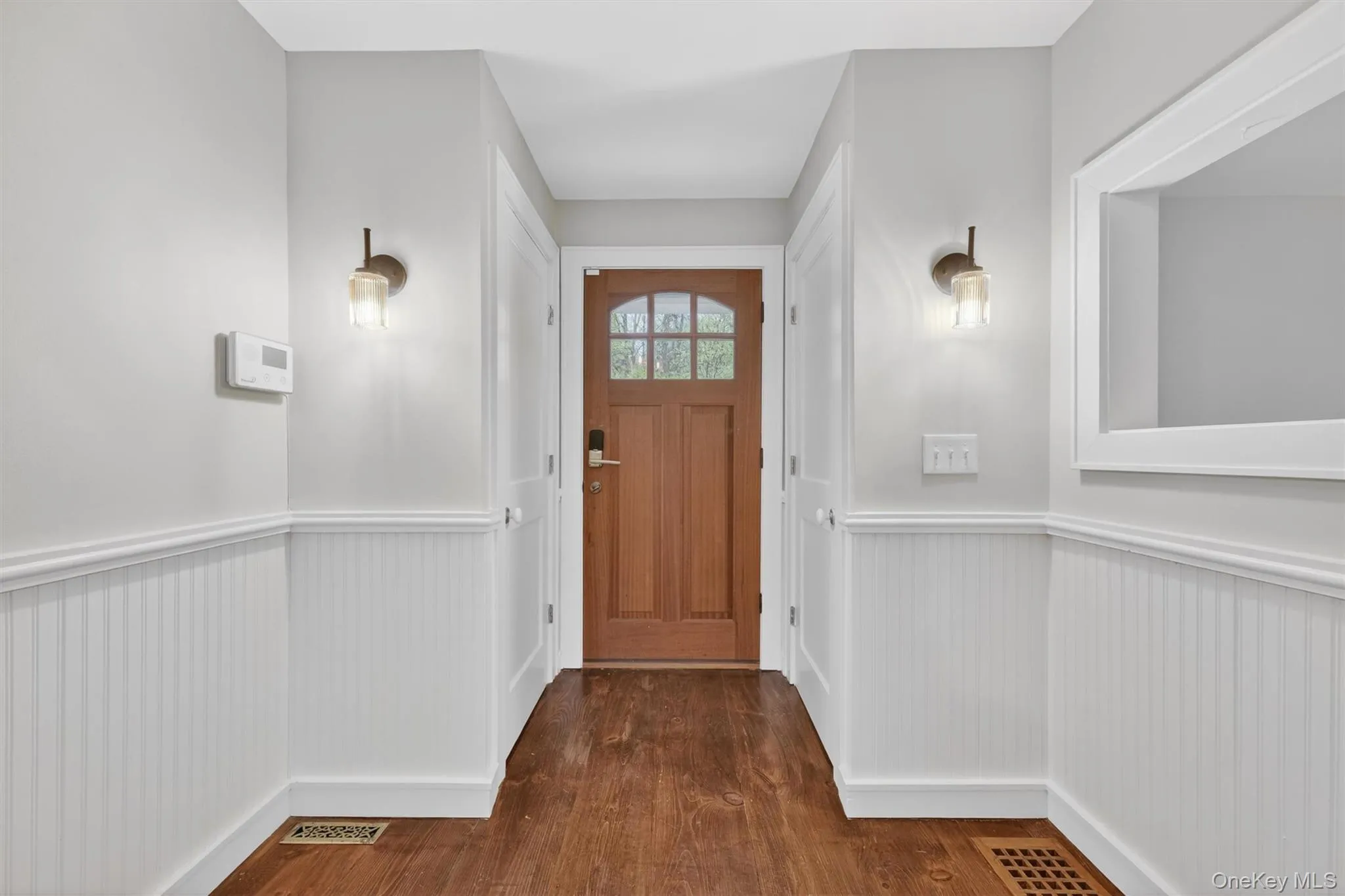 Entryway with 2 coat closets & detailed beadboard wainscoting. Entryway with 2 coat closets & detailed beadboard wainscoting.