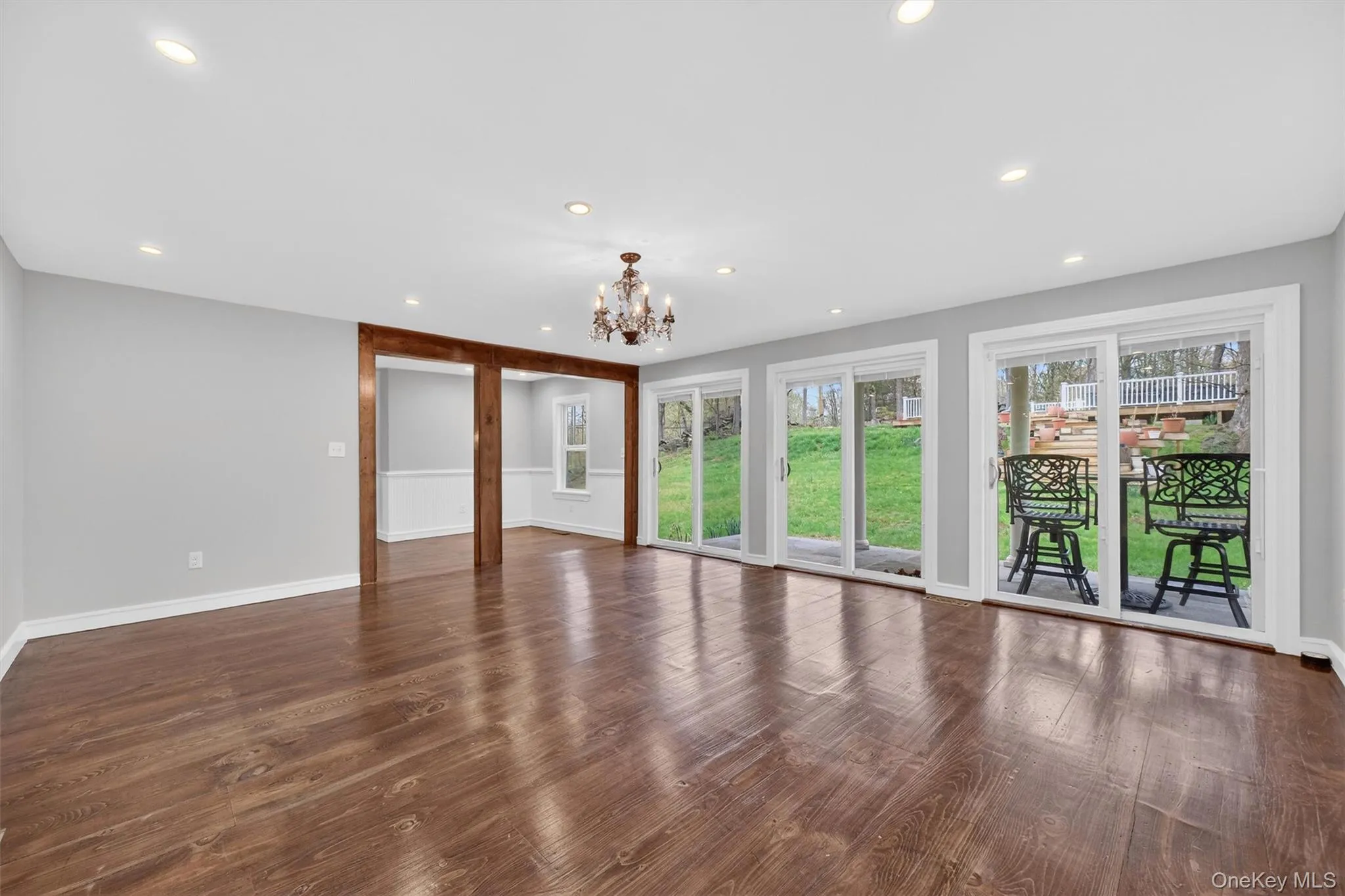Large informal living room with sliders to the patio, gardens, and deck. Large informal living room with sliders to the patio, gardens, and deck.