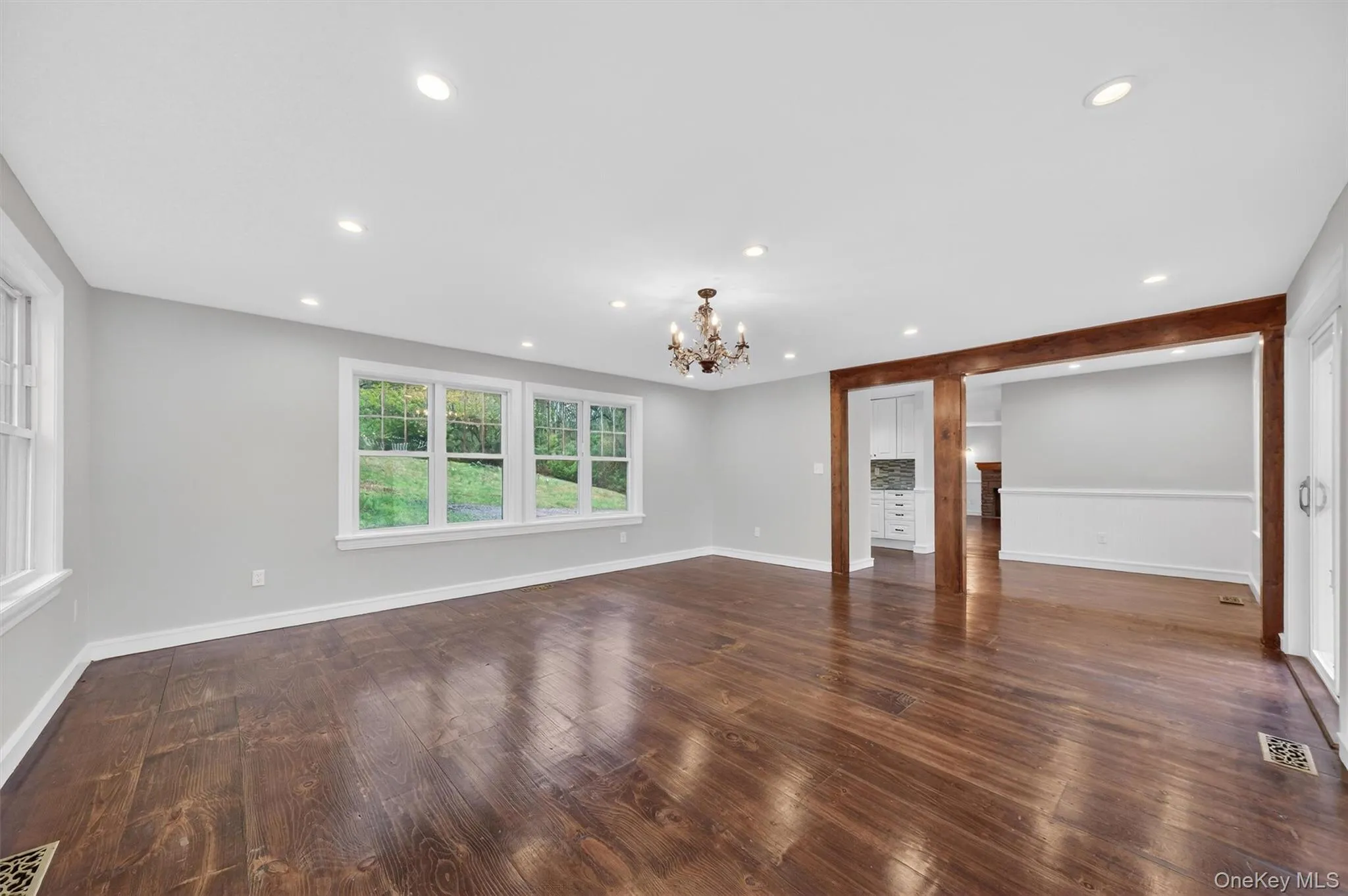 Large informal living room with sliders to the patio, gardens, and deck. Large informal living room with sliders to the patio, gardens, and deck.
