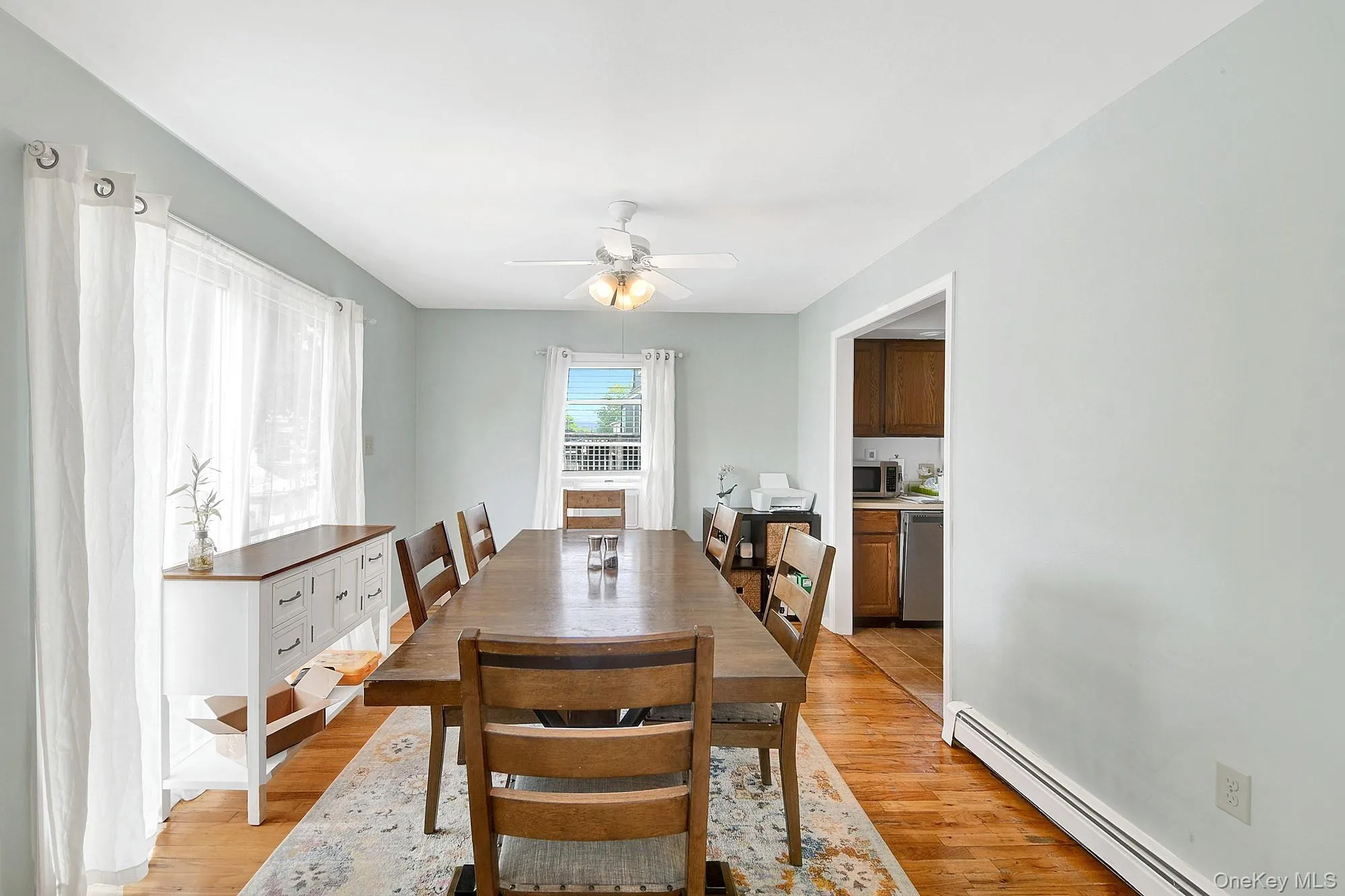 Separate dining room with double exposure, ceiling fan and hardwood floors Separate dining room with double exposure, ceiling fan and hardwood floors