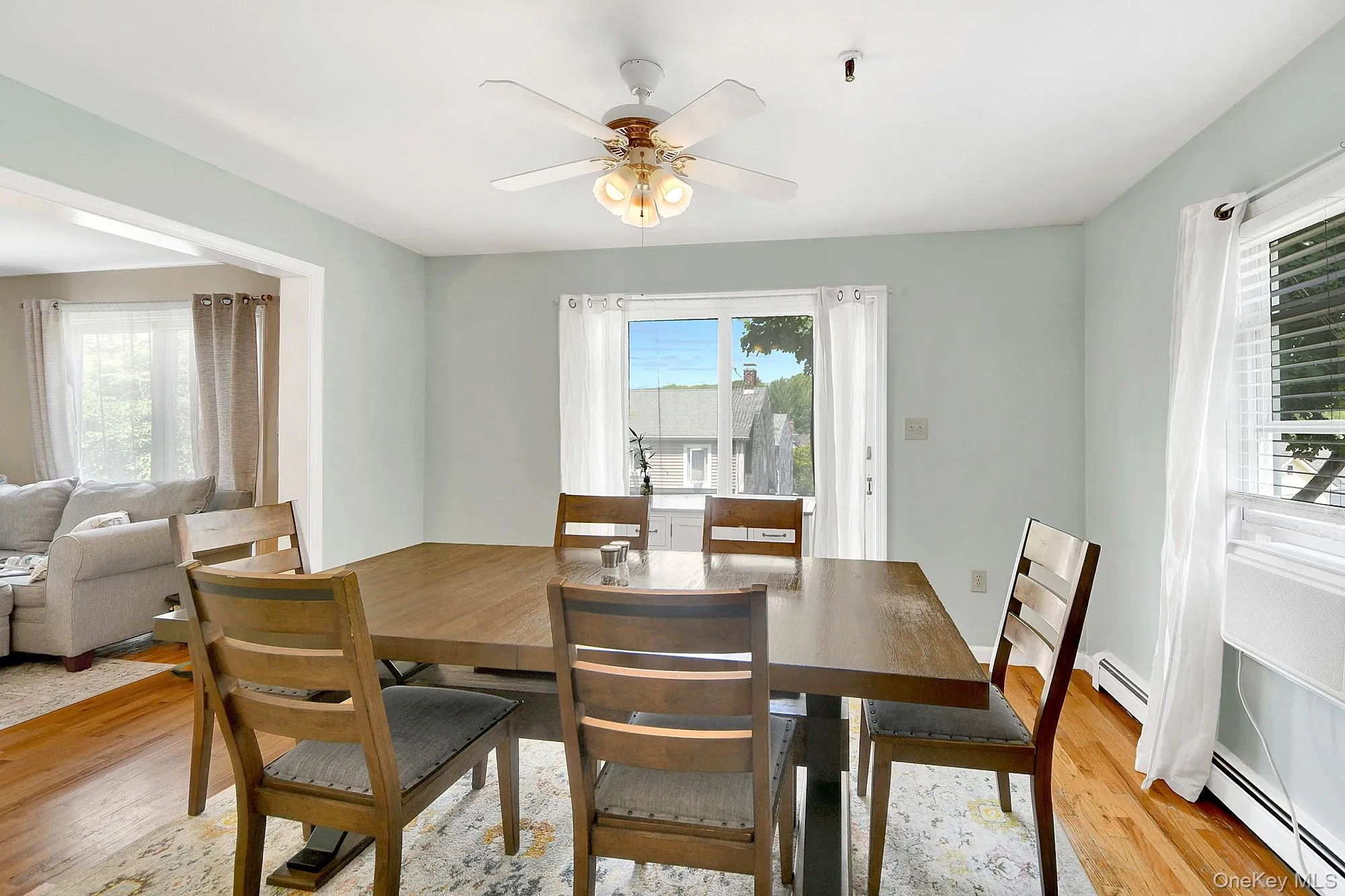 Separate dining room with double exposure, ceiling fan and hardwood floors Separate dining room with double exposure, ceiling fan and hardwood floors