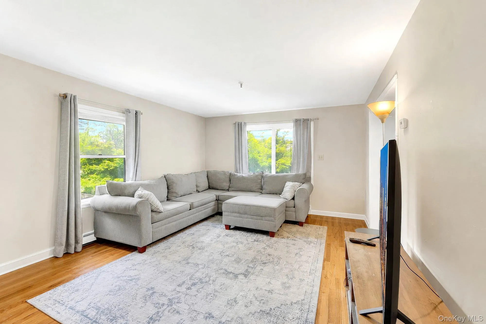 Large living room with double exposure and hardwood floors Large living room with double exposure and hardwood floors
