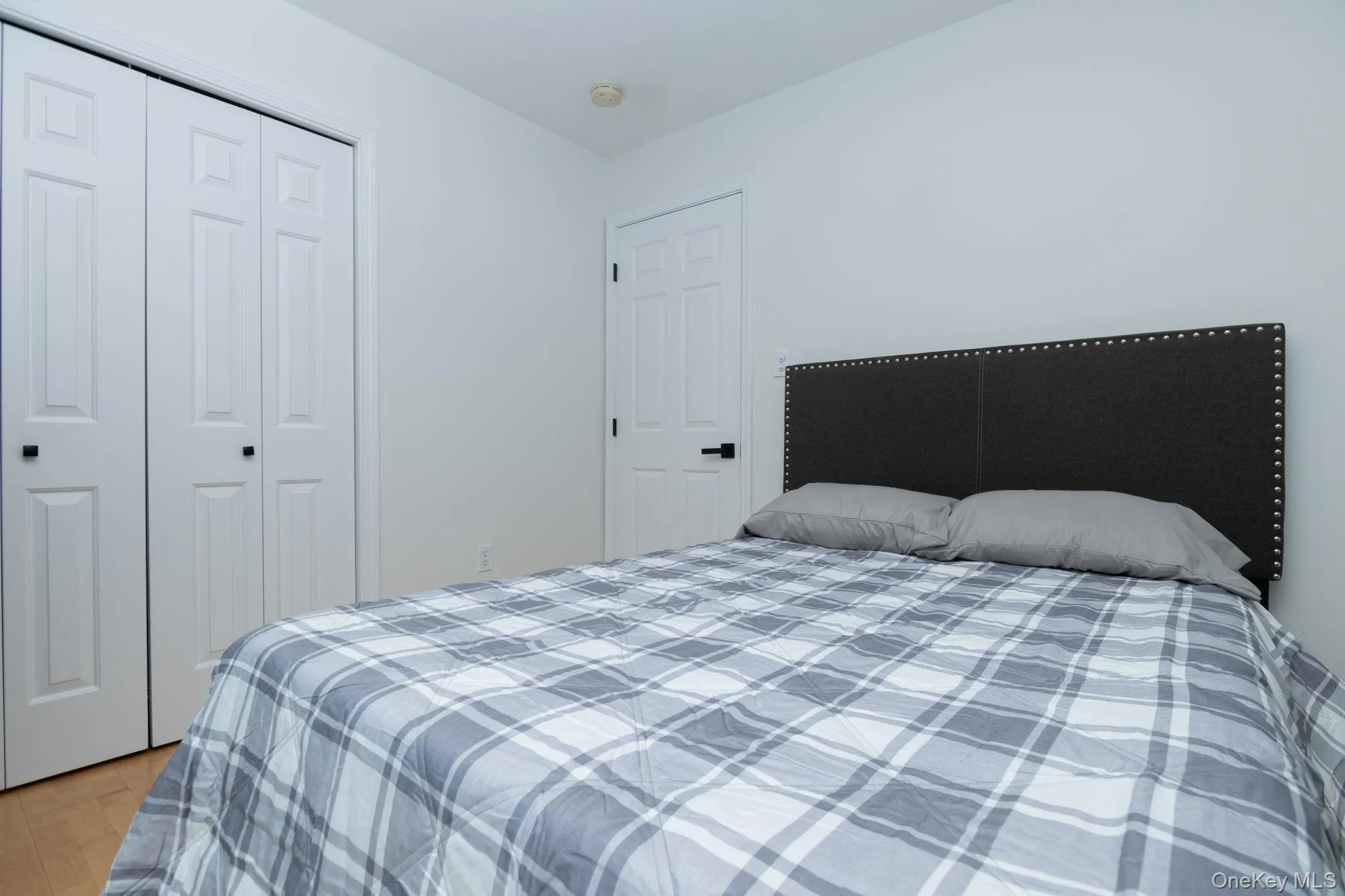 Light wood-finish flooring and white walls define this room Light wood-finish flooring and white walls define this room
