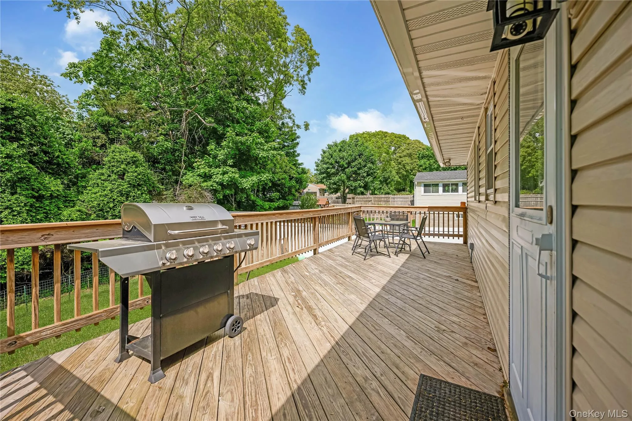 Spacious outdoor deck featuring natural wood decking and perimeter railing Spacious outdoor deck featuring natural wood decking and perimeter railing