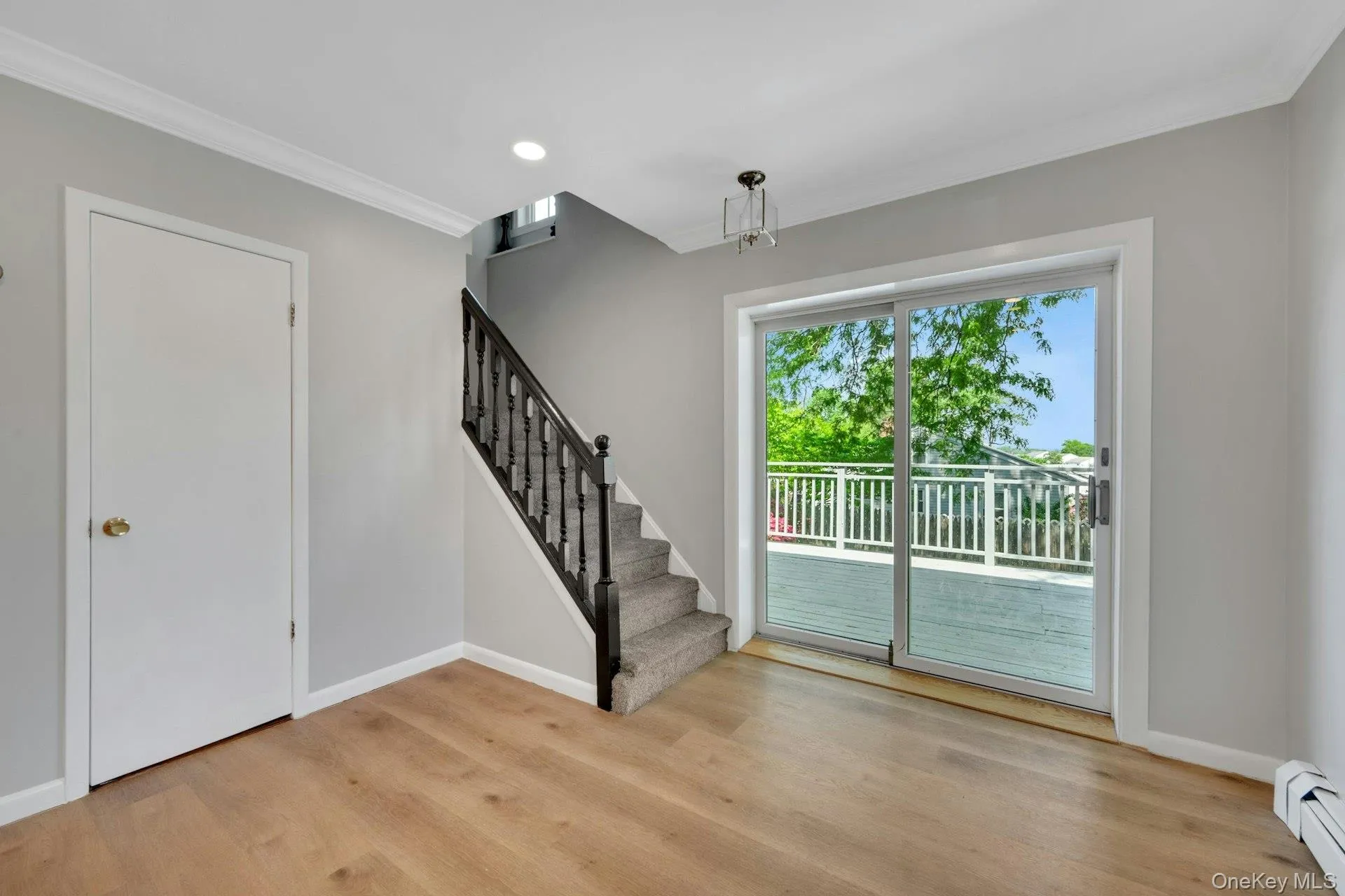 View of the first-floor sliding glass doors with a distant view of the deck View of the first-floor sliding glass doors with a distant view of the deck
