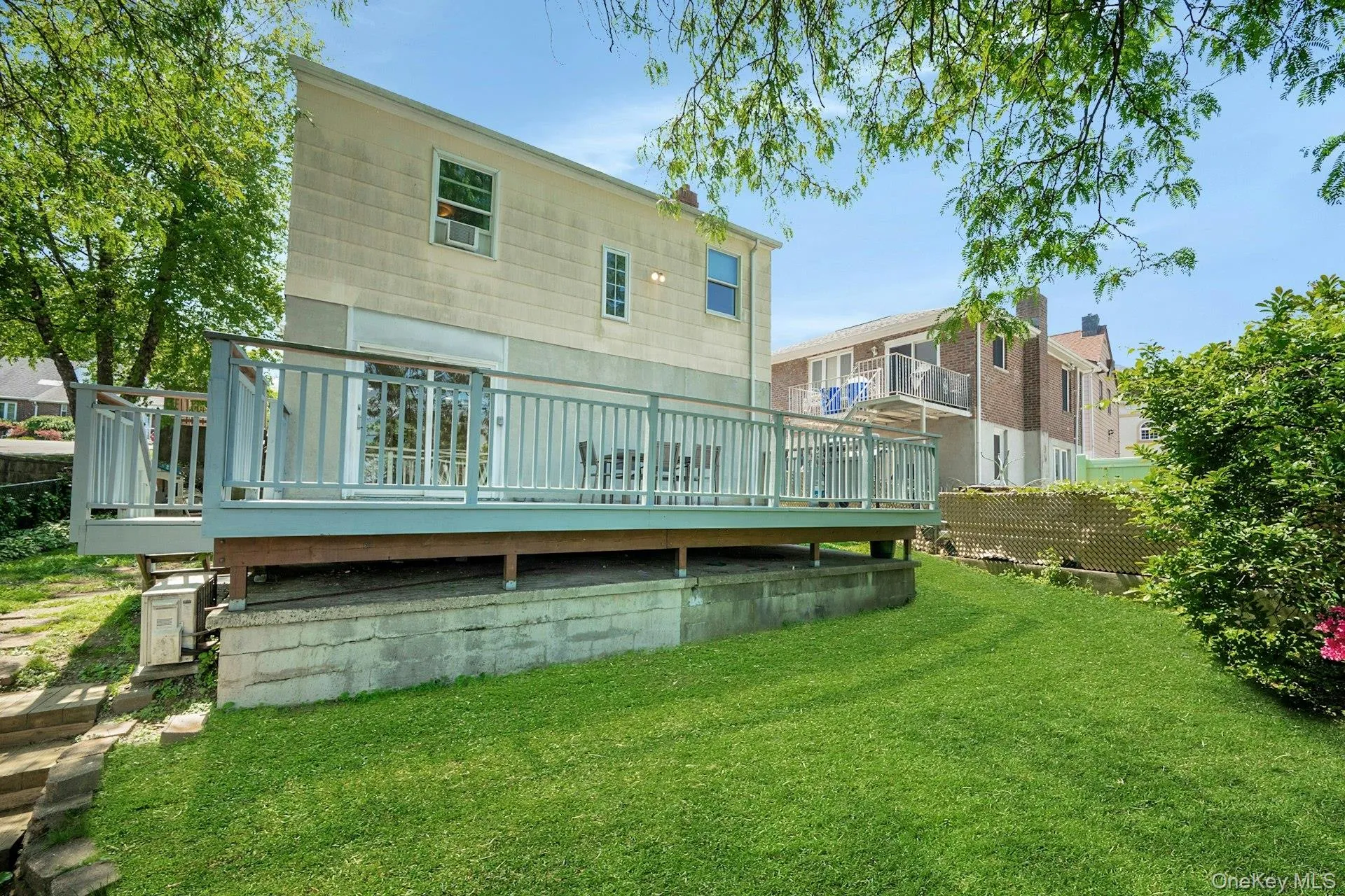 View of the back of the structure showing the deck and yard View of the back of the structure showing the deck and yard
