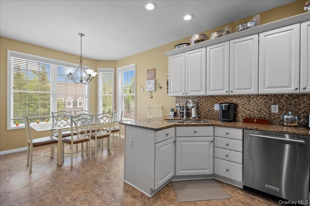 White cabinets, custom backsplash, granite counters White cabinets, custom backsplash, granite counters