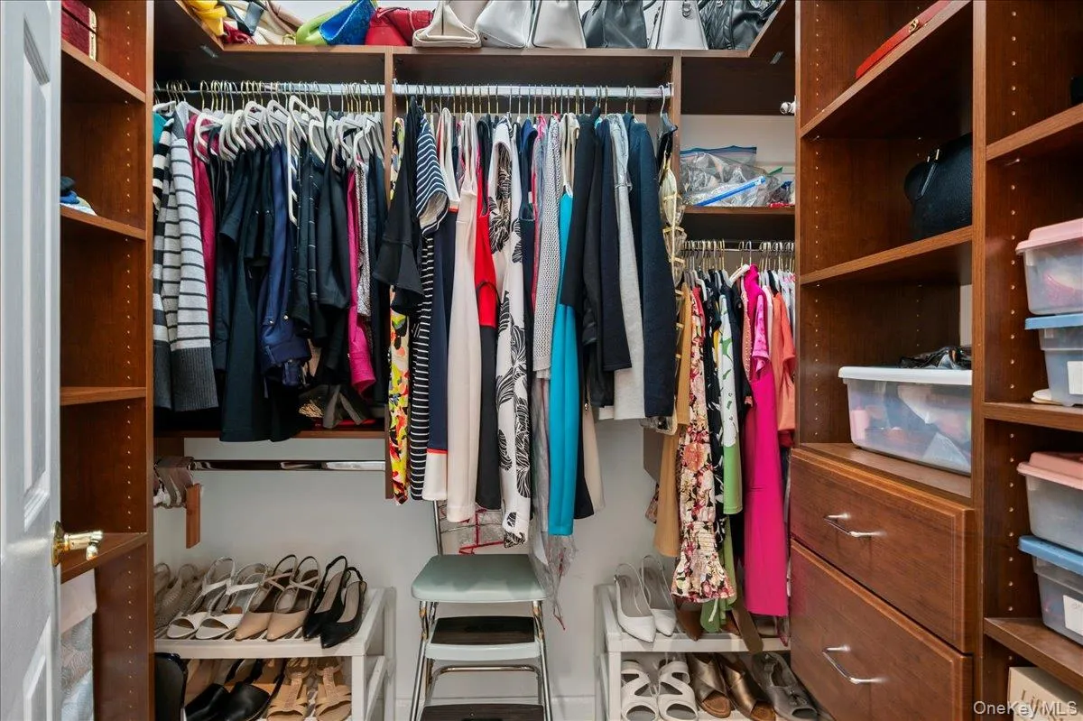 HIs and Hers Walk-In Closets with Organizers HIs and Hers Walk-In Closets with Organizers