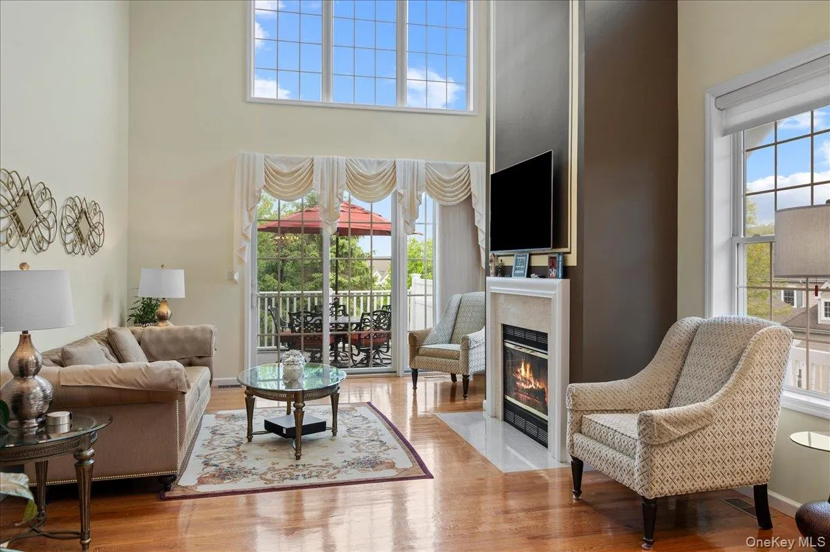 Formal living room with large windows letting in oodles of natural light Formal living room with large windows letting in oodles of natural light