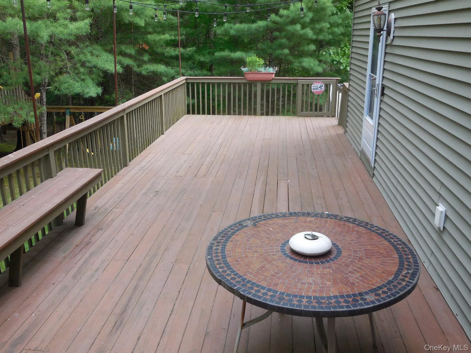 Side deck runs the length of the home with entry into home & stairs to ground level Side deck runs the length of the home with entry into home & stairs to ground level
