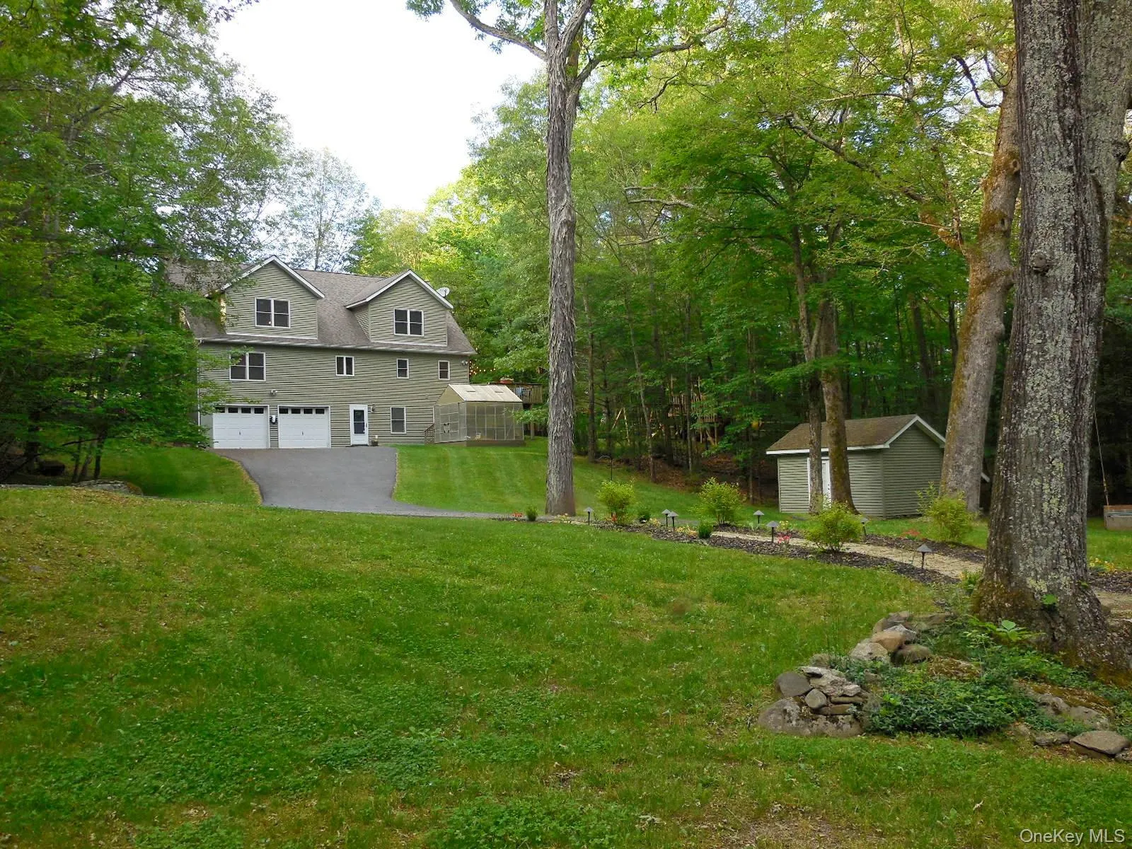 As you enter driveway, home sits well off the road. Stream, gazebo, firepit & hot tub are all to the right. As you enter driveway, home sits well off the road. Stream, gazebo, firepit & hot tub are all to the right.