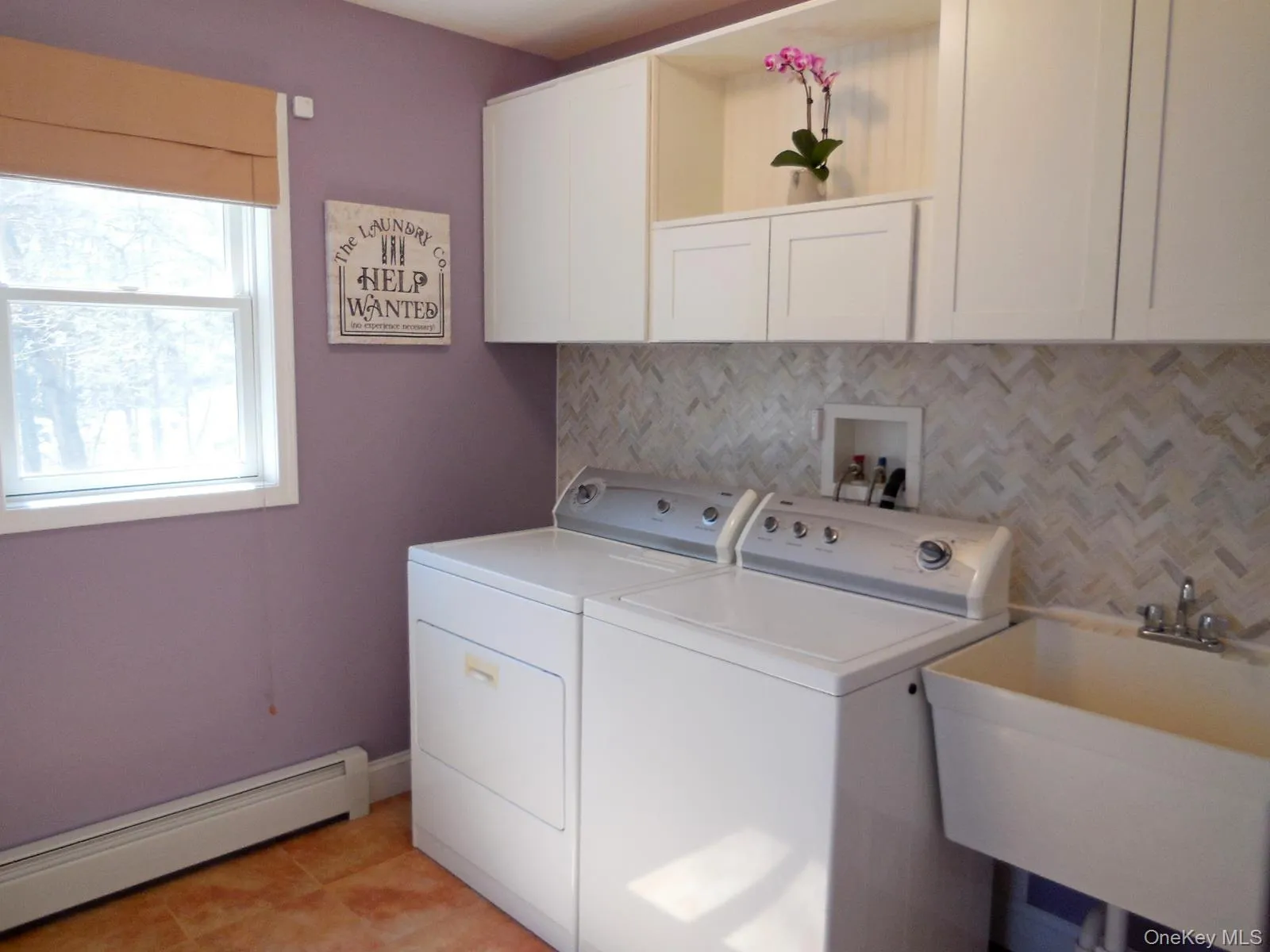 Laundry room with custom built cabinets, sink, tile floor, window, large pantry, double door closet & exterior door to rear deck. Laundry room with custom built cabinets, sink, tile floor, window, large pantry, double door closet & exterior door to rear deck.