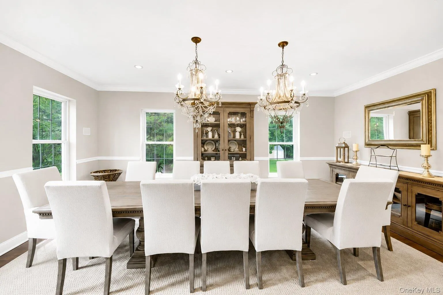 Spacious Dining Room featuring Two Ornate Arhaus Chandeliers, Recessed lighting, and Crown, Chair & Base Molding Spacious Dining Room featuring Two Ornate Arhaus Chandeliers, Recessed lighting, and Crown, Chair & Base Molding