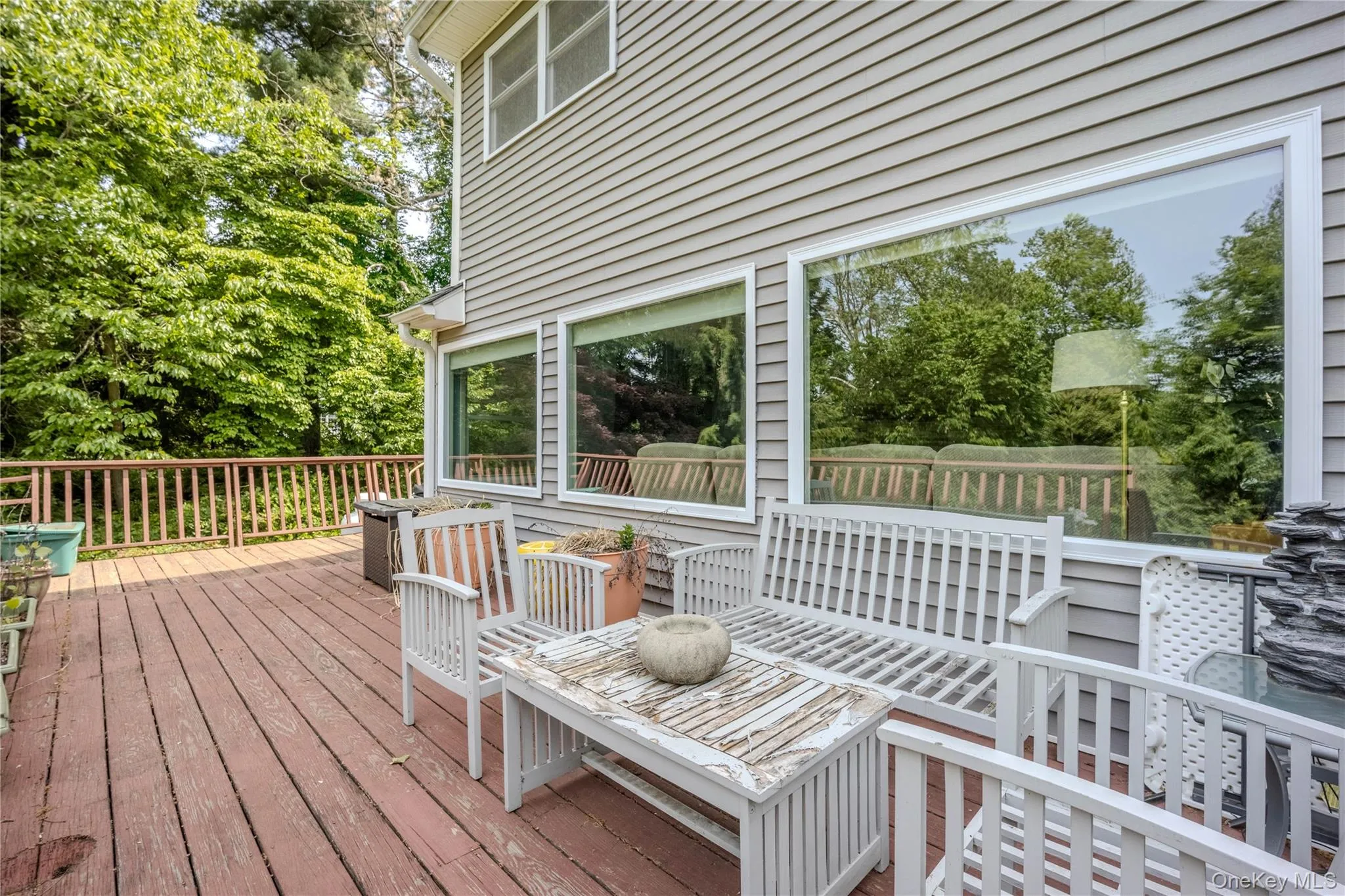 wrap around deck overlooks the backyard and inground pool wrap around deck overlooks the backyard and inground pool