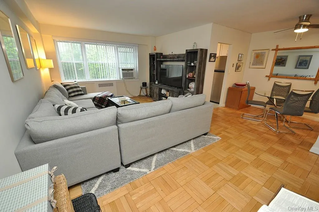 The Bright and airy living room has parquet floors, sunny Western exposures and opens to both the dining area and foyer. The living room is approx. 20'-0" x 13'-0". The Bright and airy living room has parquet floors, sunny Western exposures and opens to both the dining area and foyer. The living room is approx. 20'-0" x 13'-0".