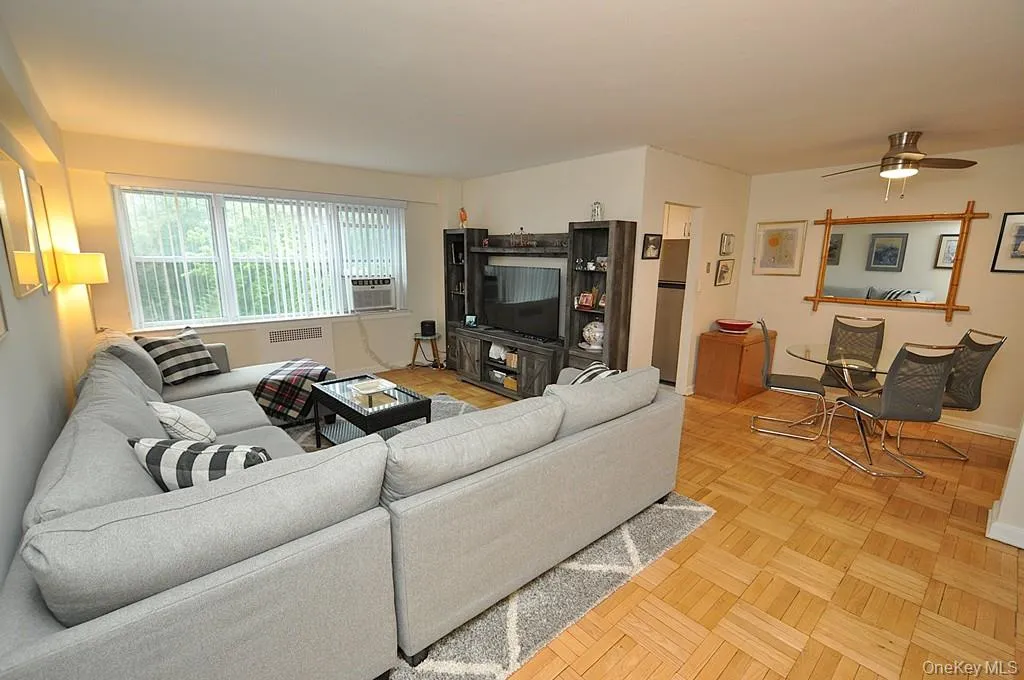 The Bright and airy living room has parquet floors, sunny Western exposures and opens to both the dining area and foyer. The living room is approx. 20'-0" x 13'-0". The Bright and airy living room has parquet floors, sunny Western exposures and opens to both the dining area and foyer. The living room is approx. 20'-0" x 13'-0".