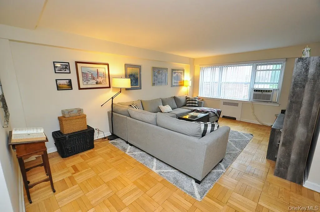 The Bright and airy living room has parquet floors, sunny Western exposures and opens to both the dining area and foyer. The living room is approx. 20'-0" x 13'-0". The Bright and airy living room has parquet floors, sunny Western exposures and opens to both the dining area and foyer. The living room is approx. 20'-0" x 13'-0".