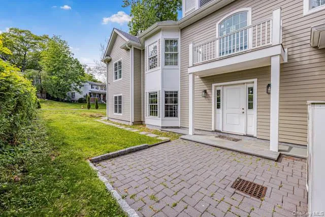 Contemporary facade with horizontal siding and a paver driveway Contemporary facade with horizontal siding and a paver driveway