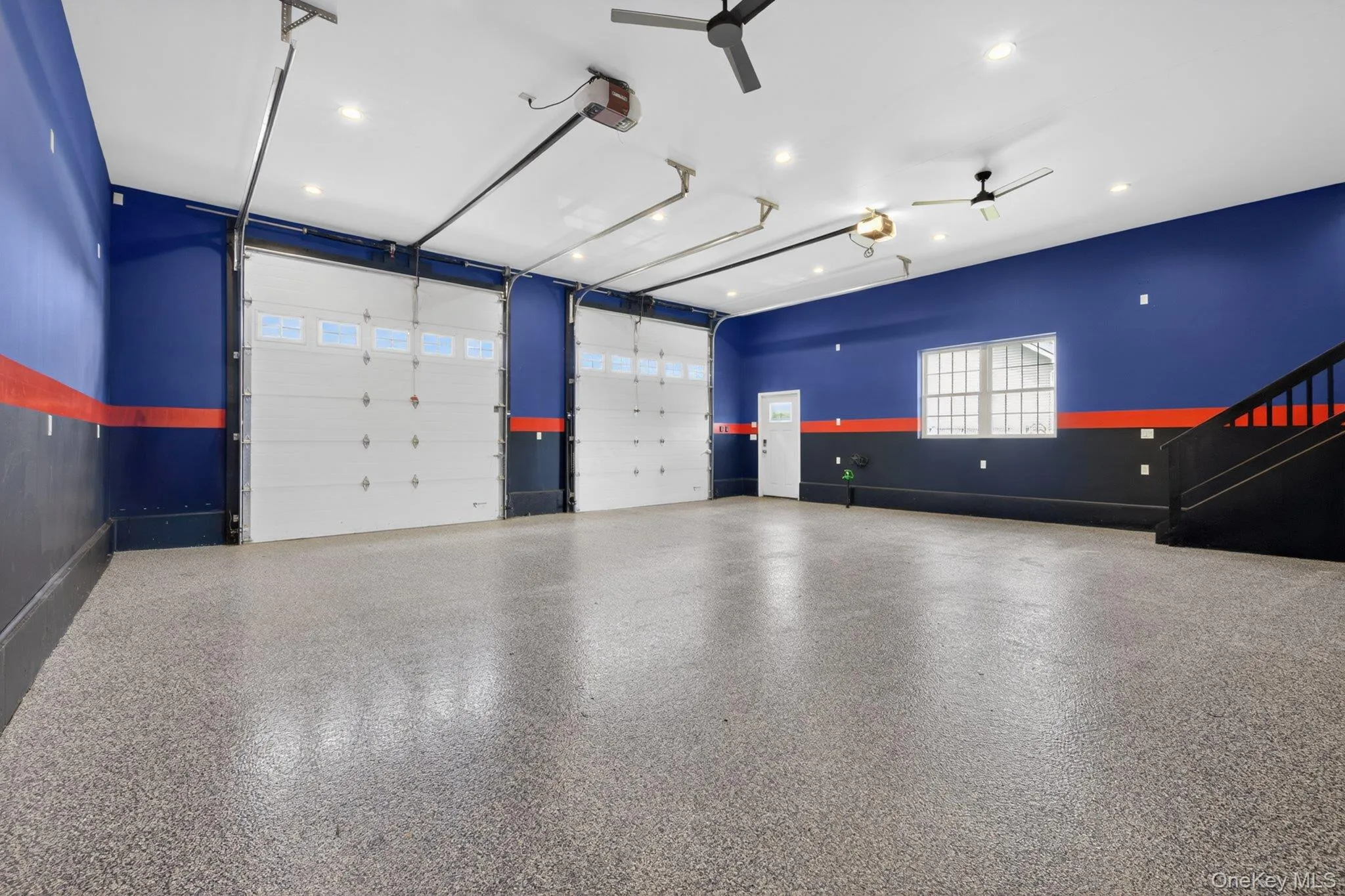 Spacious garage featuring two overhead doors with window panels Spacious garage featuring two overhead doors with window panels