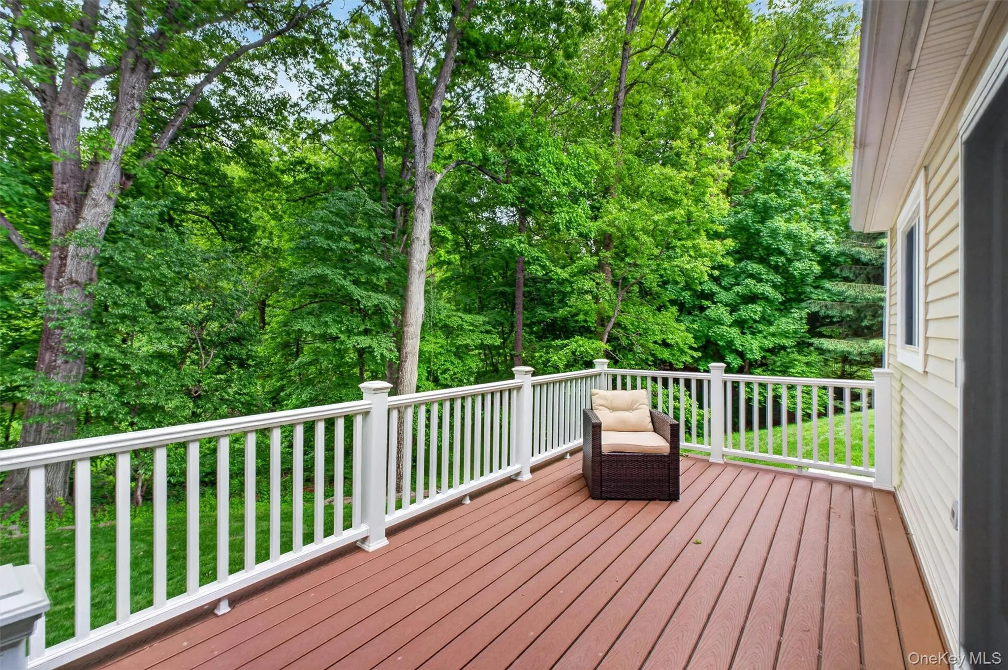 Enjoy peaceful wooded views from the elevated rear deck. Enjoy peaceful wooded views from the elevated rear deck.