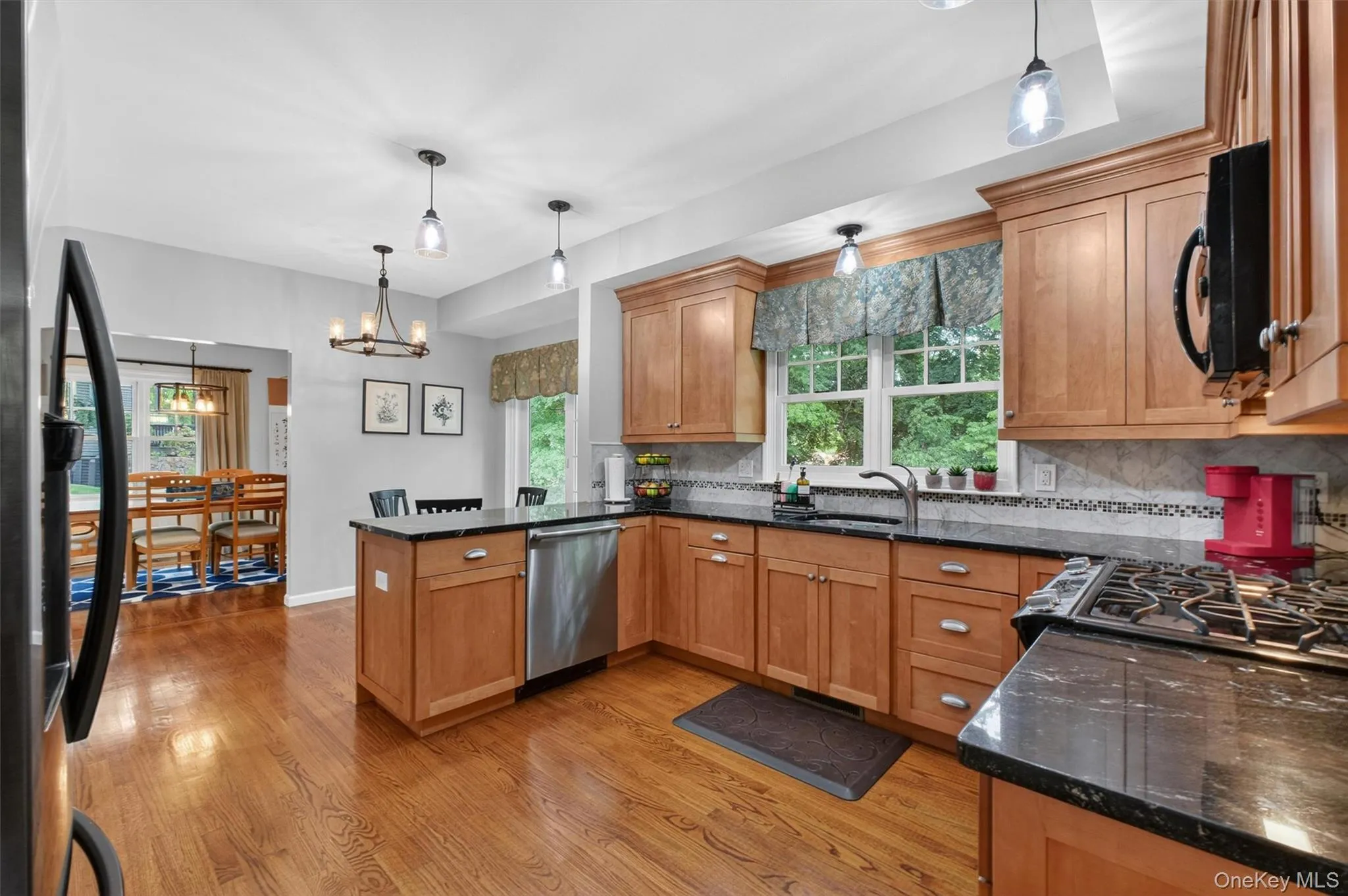 Kitchen with breakfast area and seamless flow to dining and living spaces Kitchen with breakfast area and seamless flow to dining and living spaces