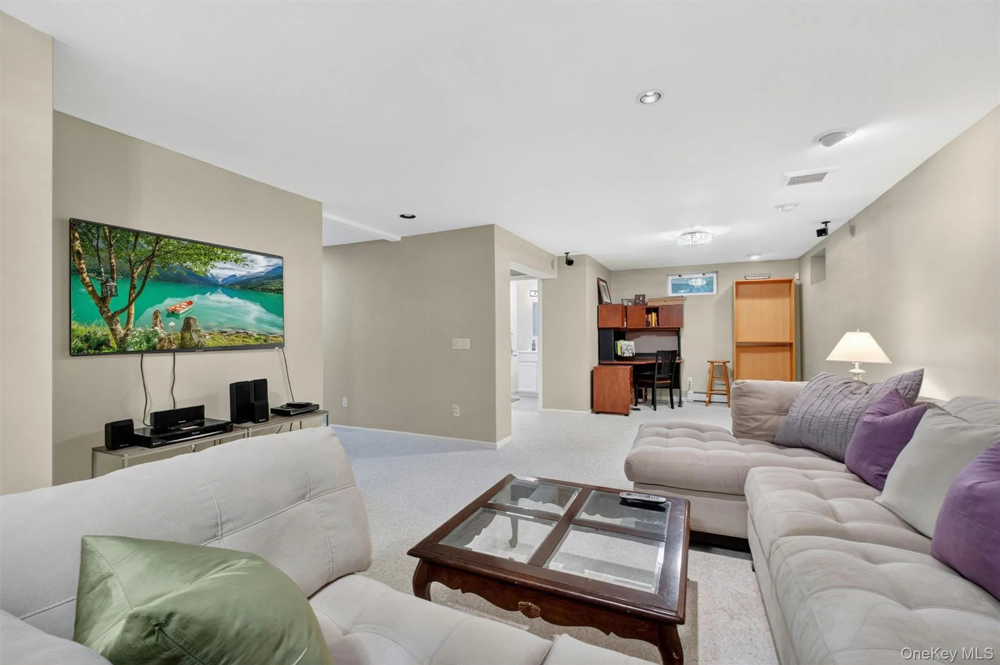 Bright and expansive lower level ideal for movie nights, game days, or a home gym setup. Bright and expansive lower level ideal for movie nights, game days, or a home gym setup.