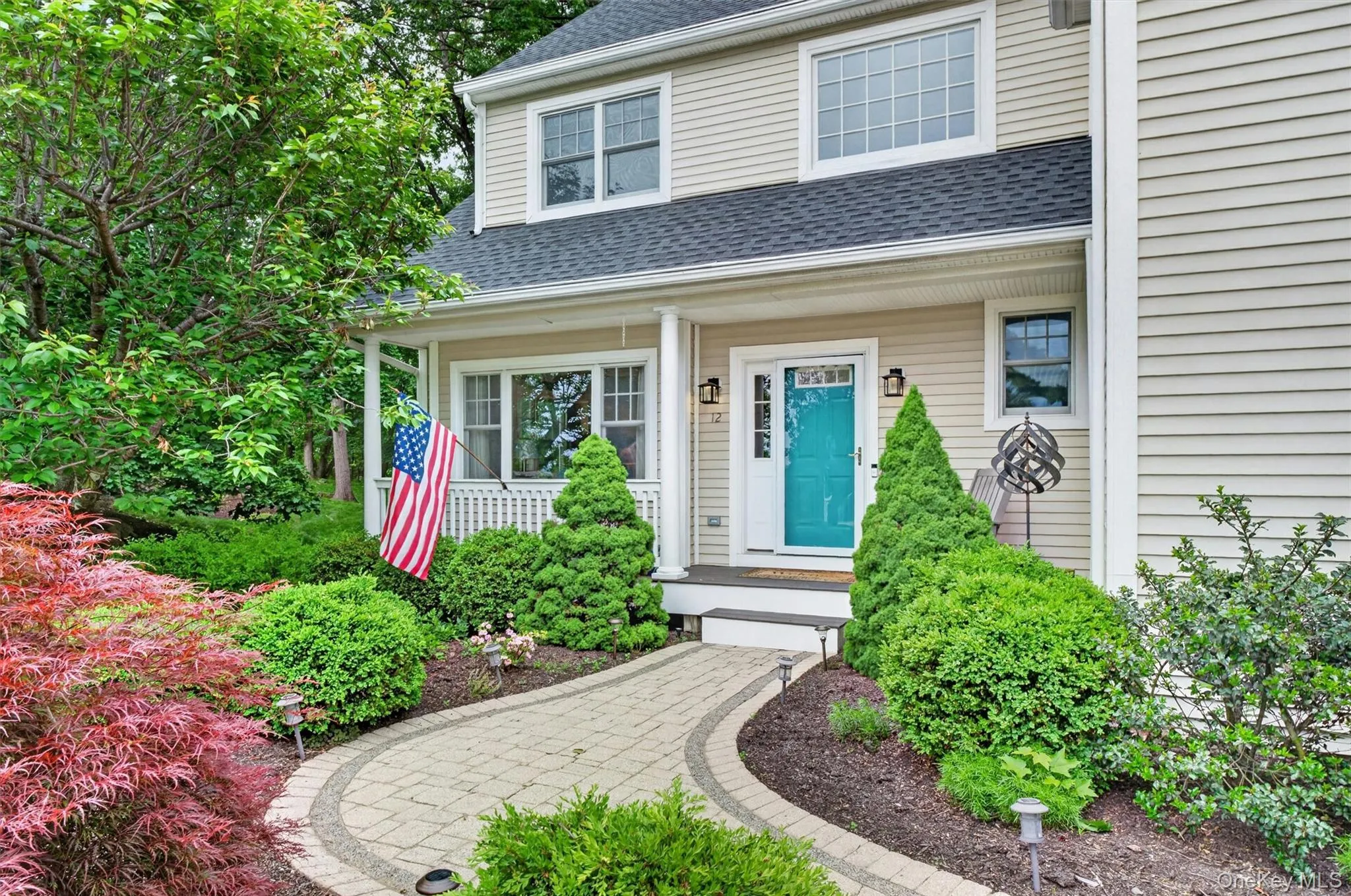 Welcoming covered front porch with manicured grounds and inviting curb appeal. Welcoming covered front porch with manicured grounds and inviting curb appeal.