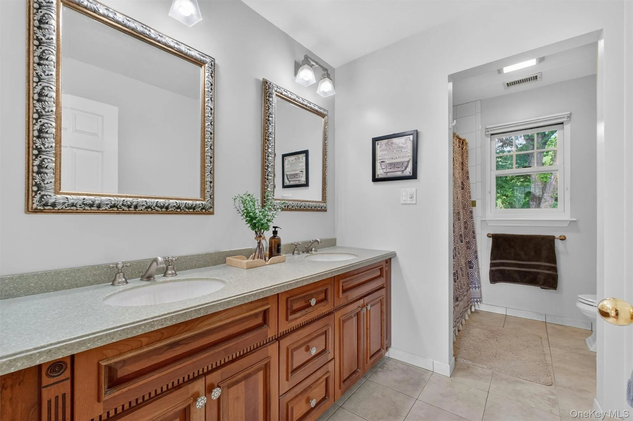 Well-appointed full bath with double vanity and classic finishes. Well-appointed full bath with double vanity and classic finishes.