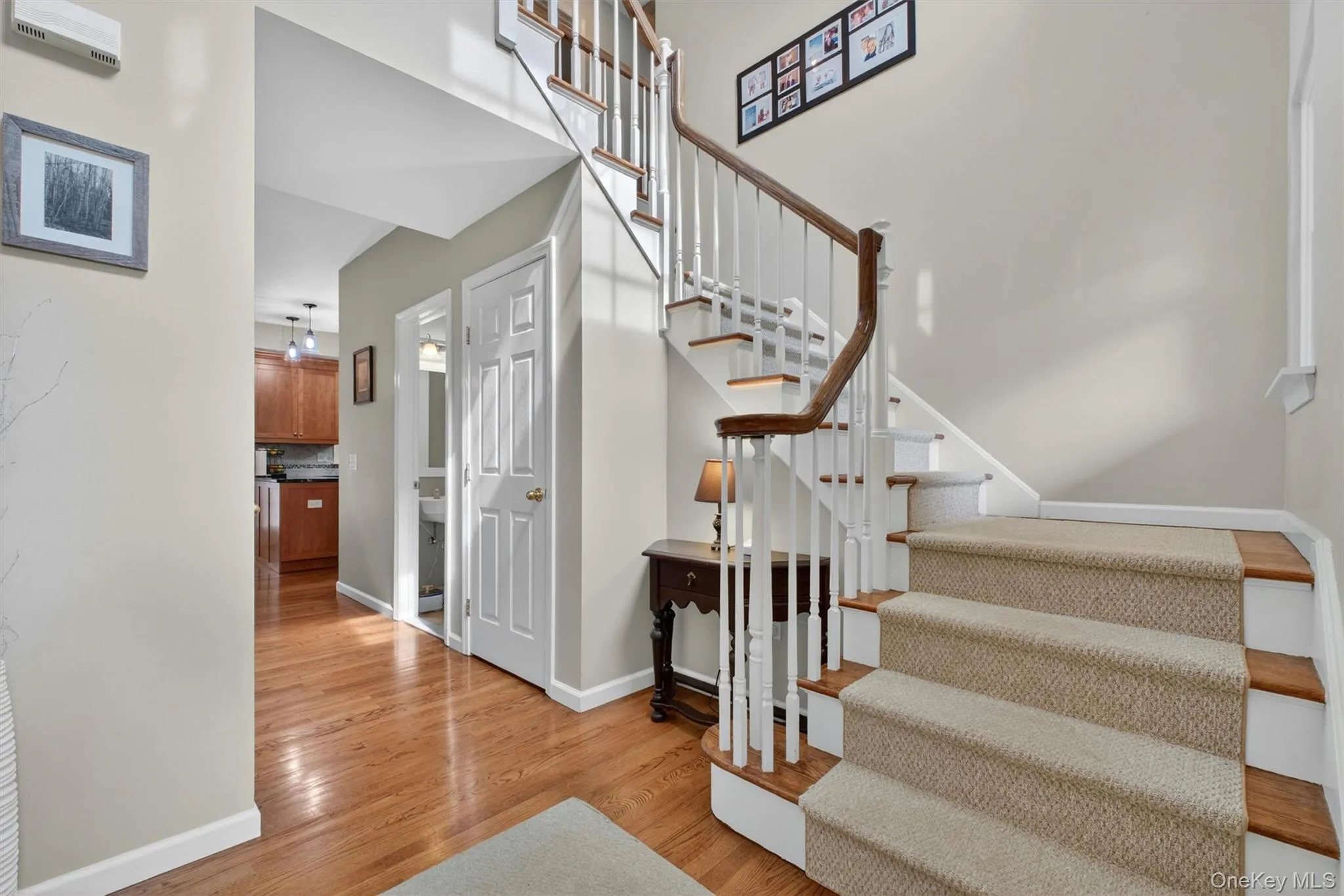 Bright two-story entry foyer with hardwood floors and dramatic staircase. Bright two-story entry foyer with hardwood floors and dramatic staircase.