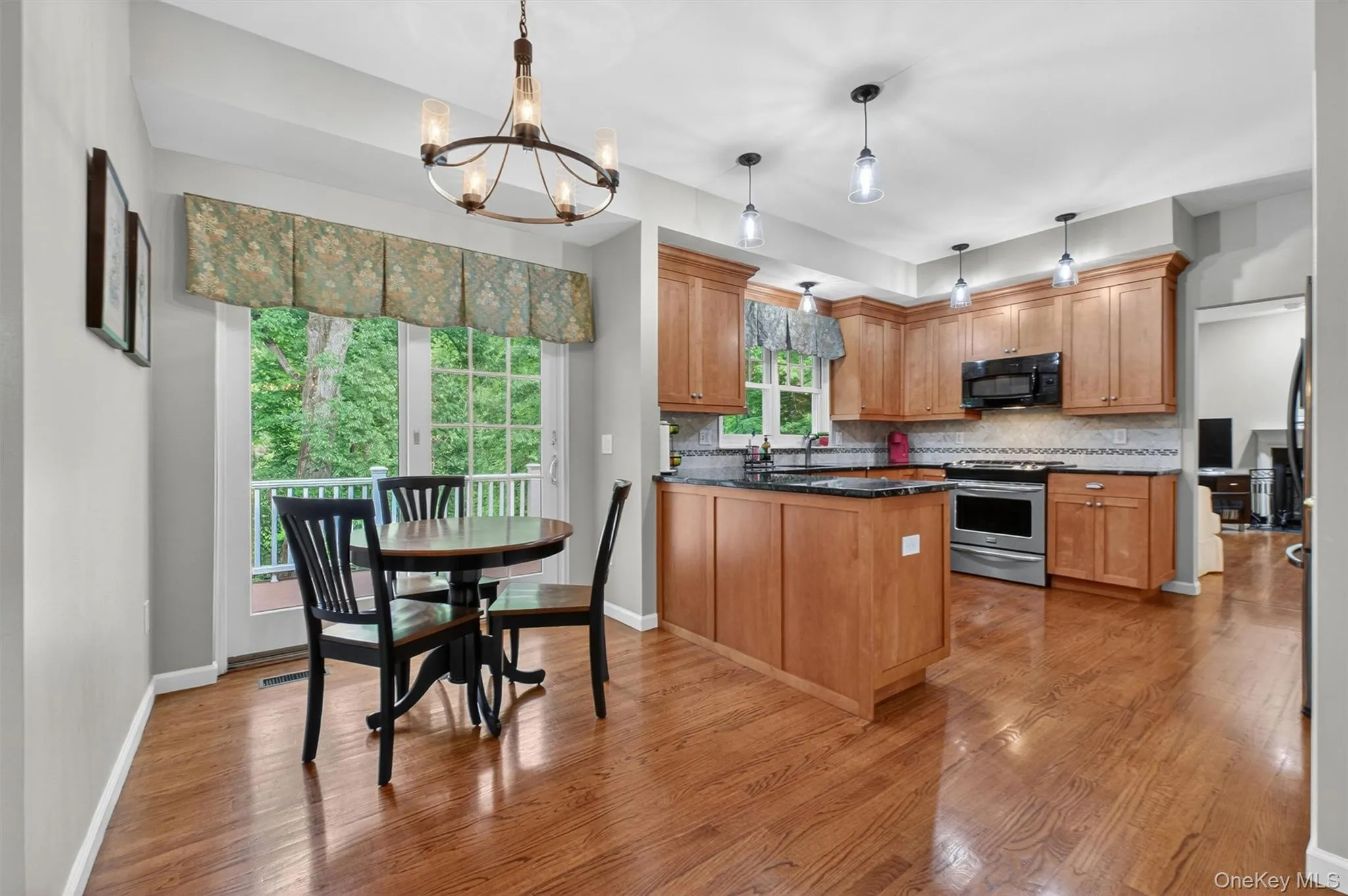 Updated eat-in kitchen with granite countertops and abundant cabinetry. Updated eat-in kitchen with granite countertops and abundant cabinetry.