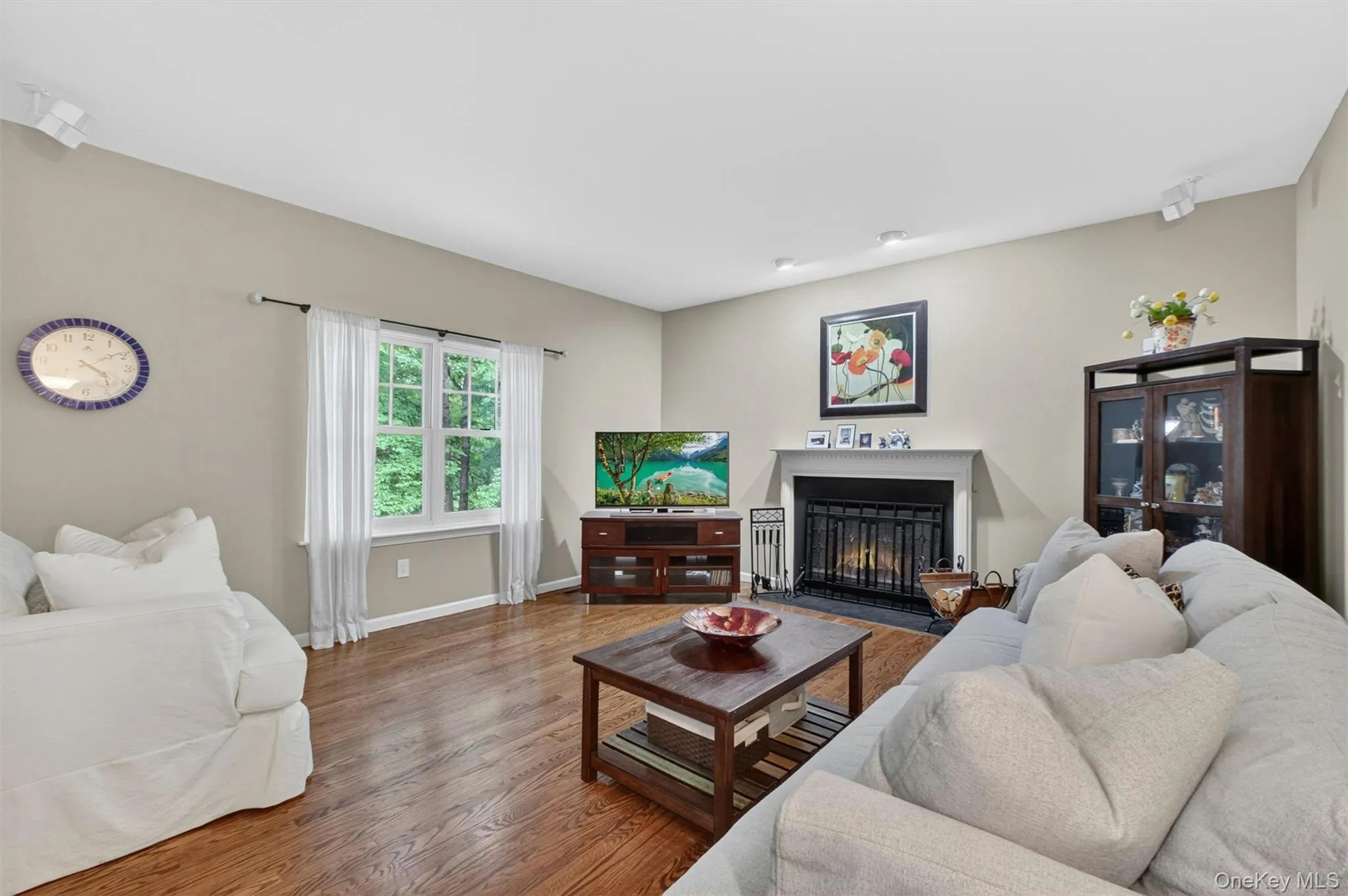 Comfortable family room with hardwood floors and cozy fireplace. Comfortable family room with hardwood floors and cozy fireplace.