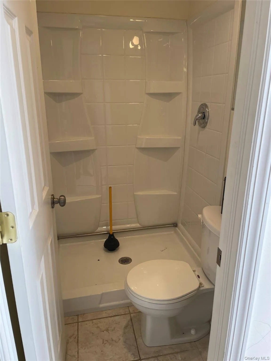 bathroom located in rear of space bathroom located in rear of space