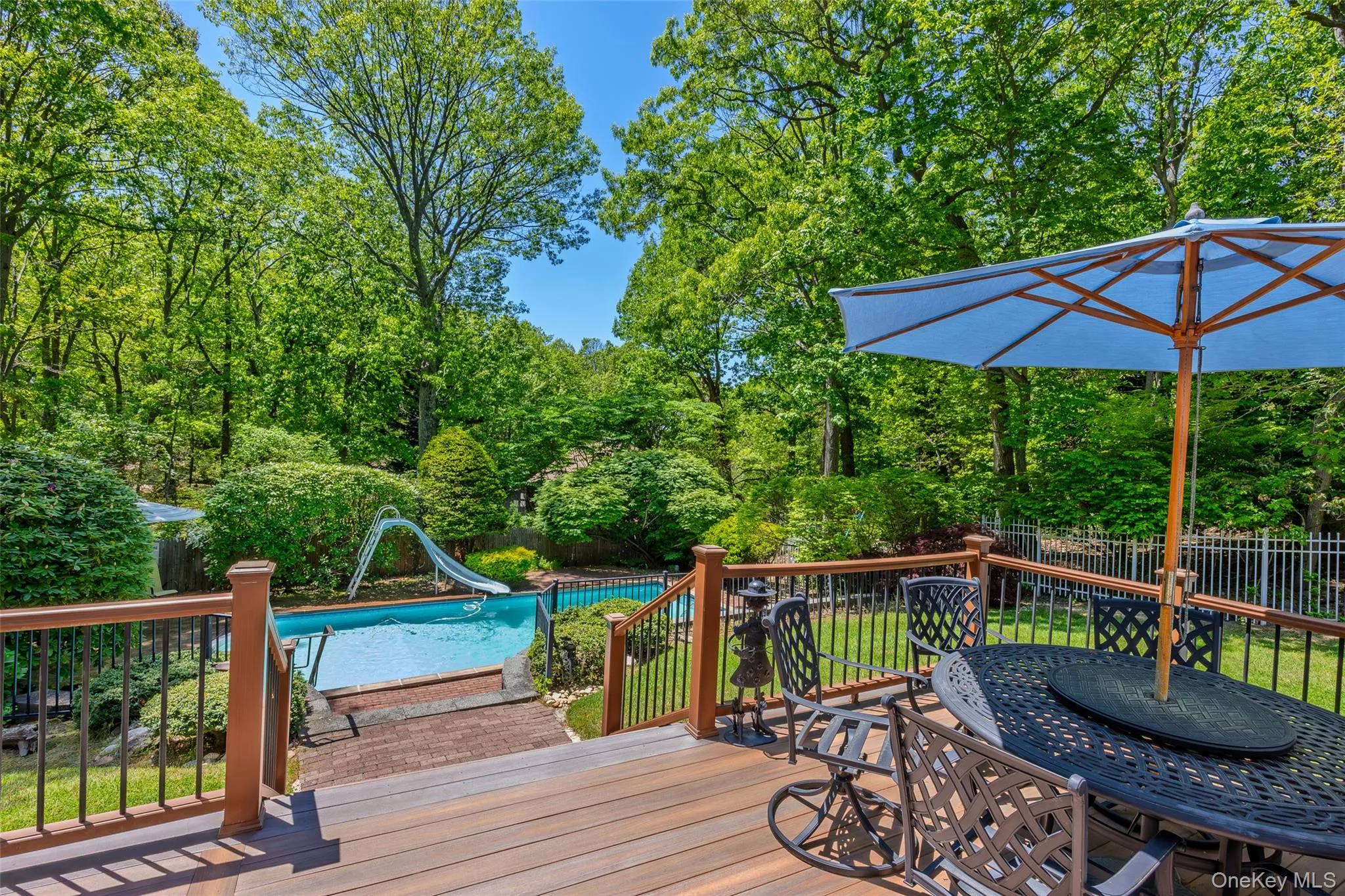 Lovely composite decking overlooking in ground pool Lovely composite decking overlooking in ground pool
