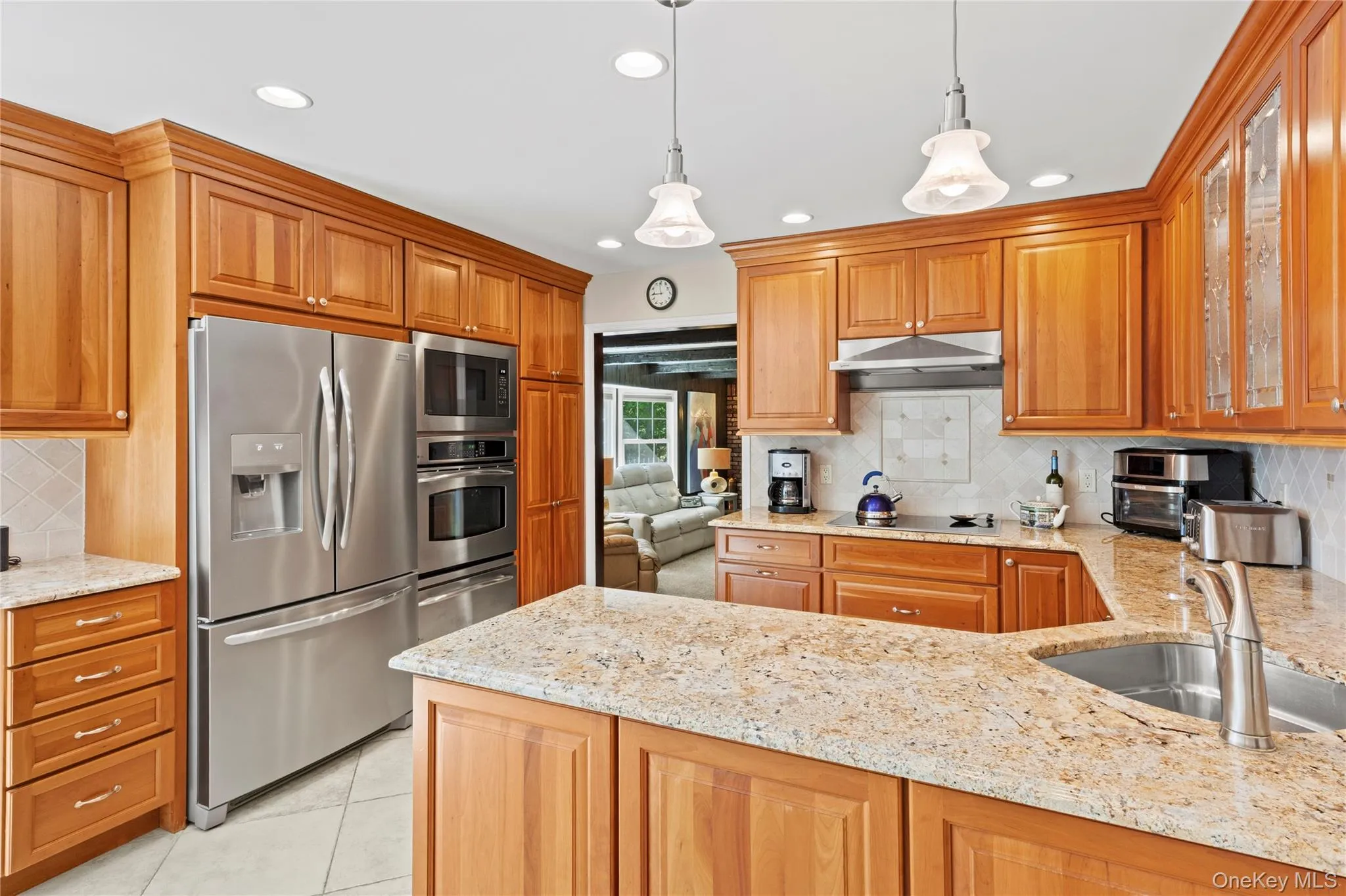 Highlights of the kitchen include custom wood cabinetry, granite countertops, stainless stell appliances, recessed lighting Highlights of the kitchen include custom wood cabinetry, granite countertops, stainless stell appliances, recessed lighting