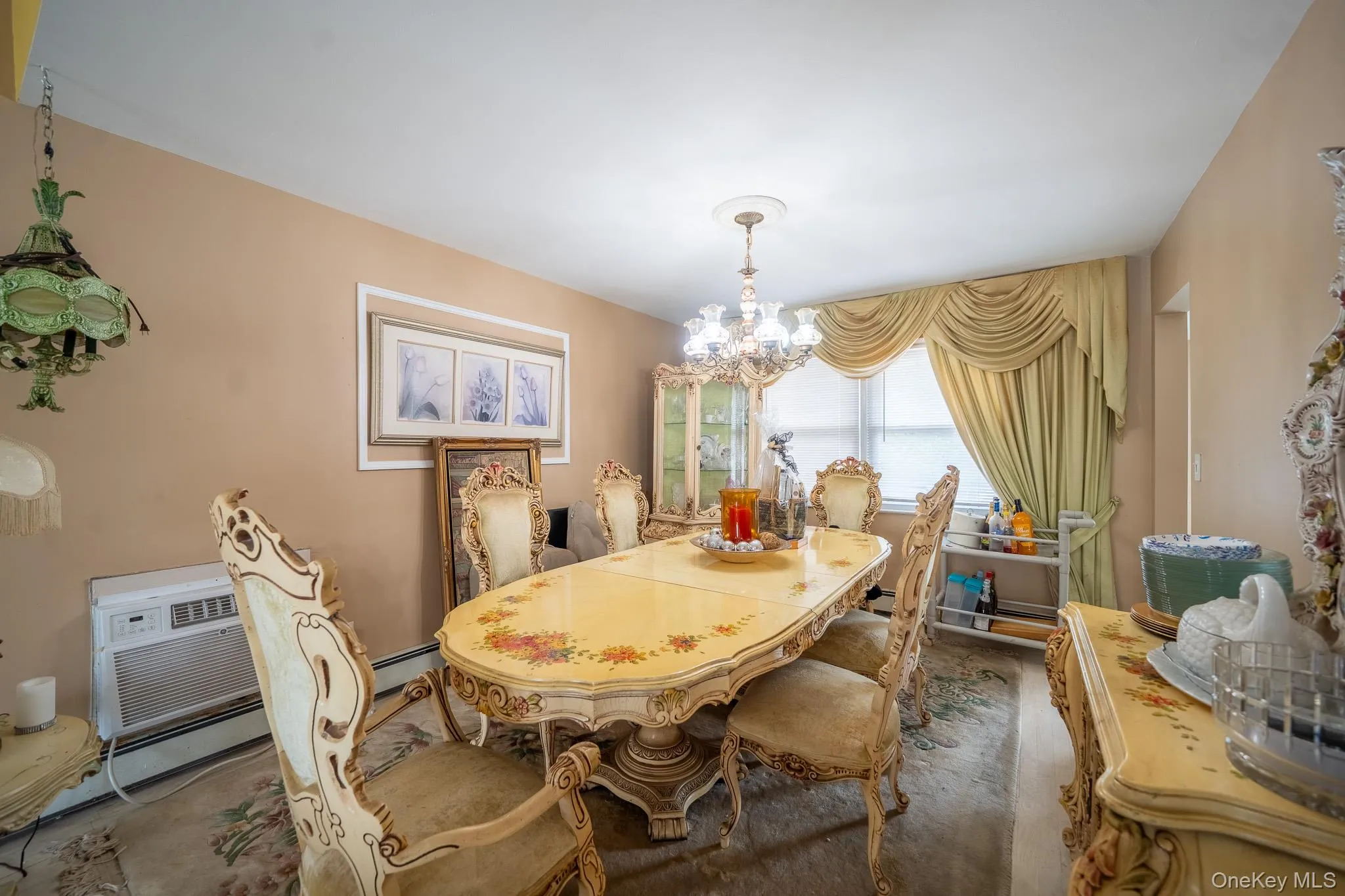 Dining area with carpet, a chandelier, and a baseboard heating unit Dining area with carpet, a chandelier, and a baseboard heating unit