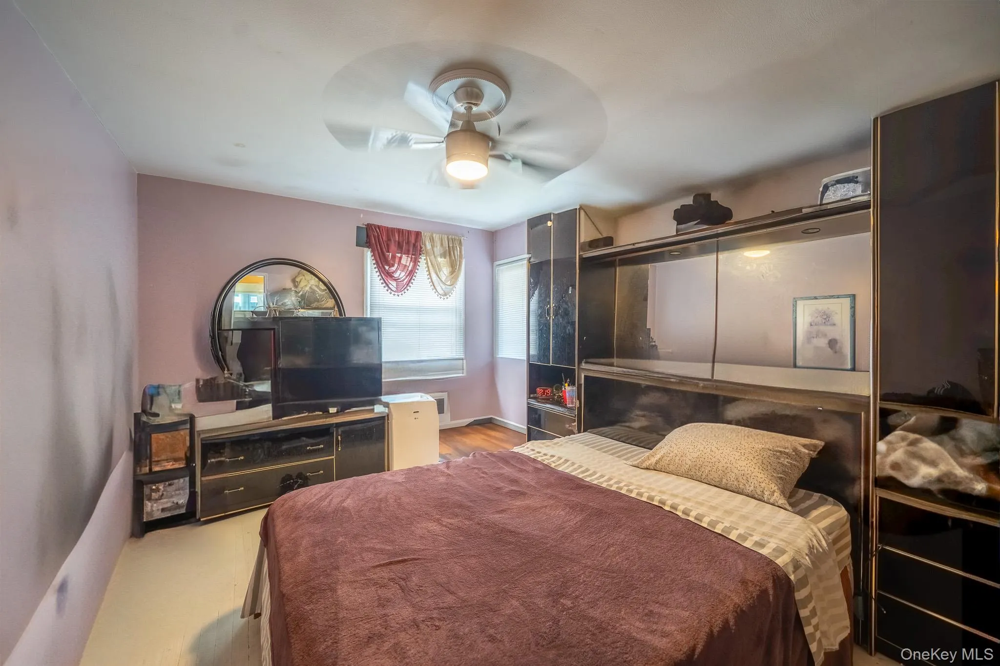 Bedroom featuring ceiling fan and baseboards Bedroom featuring ceiling fan and baseboards