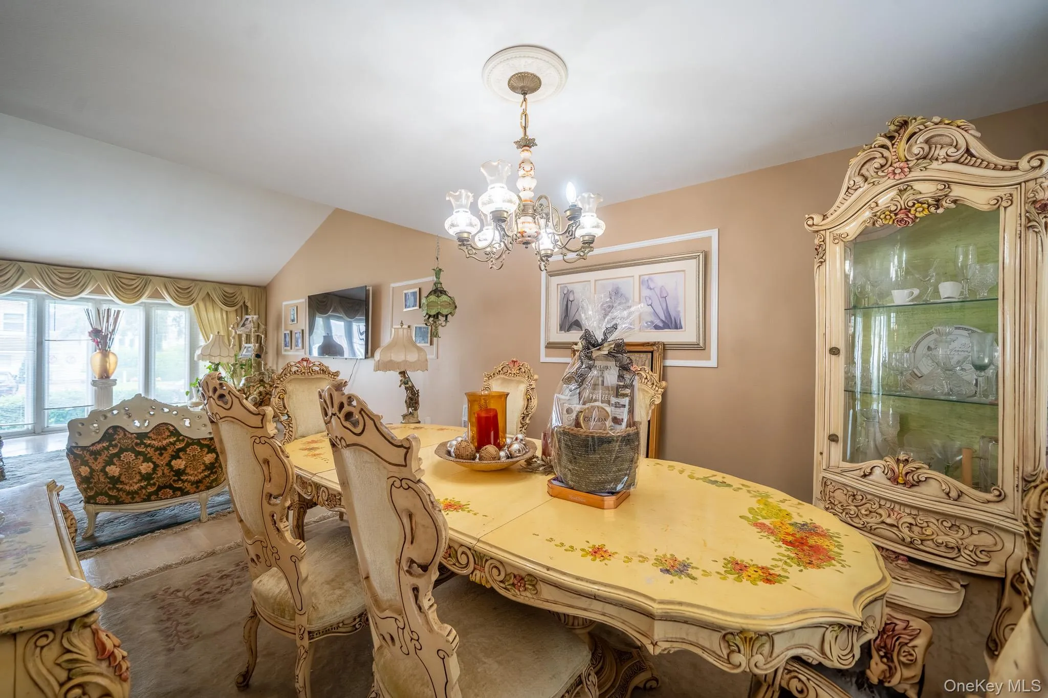Dining space with a chandelier and vaulted ceiling Dining space with a chandelier and vaulted ceiling