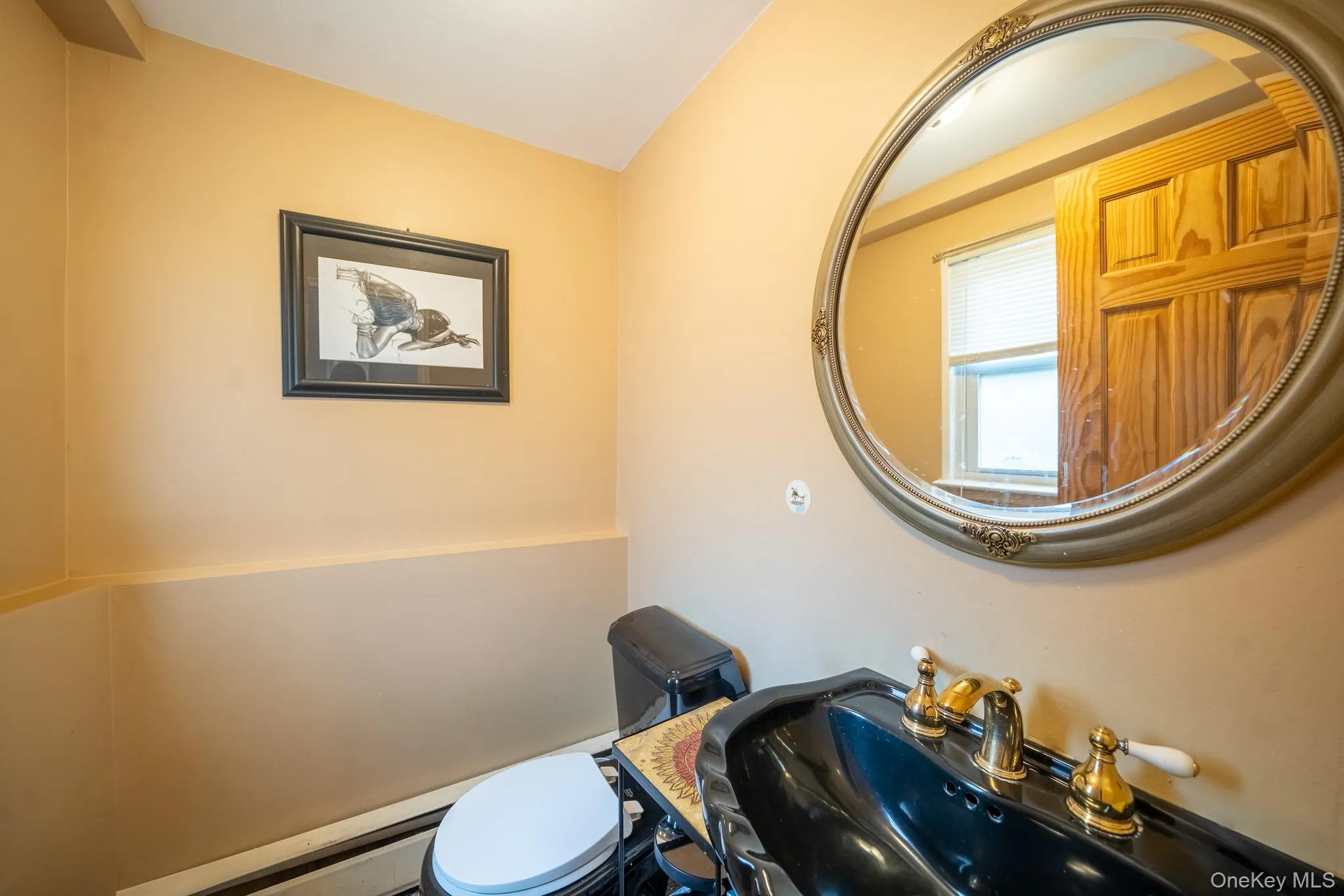 Bathroom with toilet and a baseboard heating unit Bathroom with toilet and a baseboard heating unit