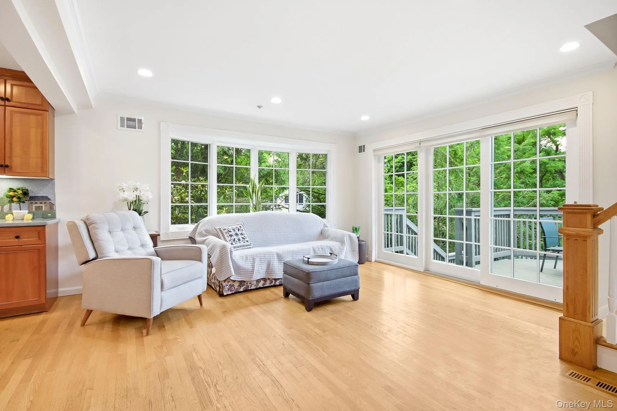 Sun filled family room with oversized windows and walk out to deck overlooking back yard Sun filled family room with oversized windows and walk out to deck overlooking back yard