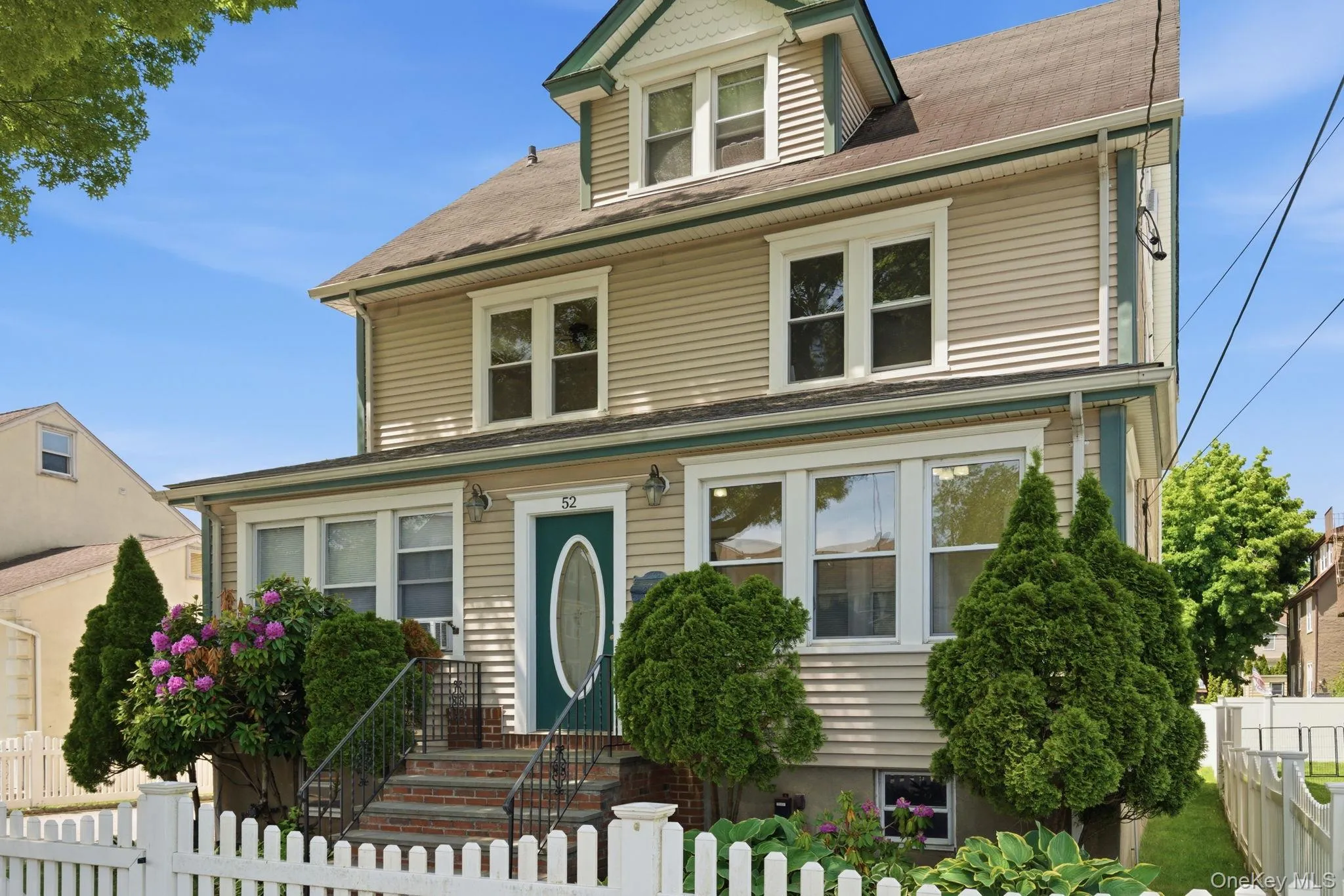 Light beige horizontal siding exterior with white window trim and a teal front door Light beige horizontal siding exterior with white window trim and a teal front door