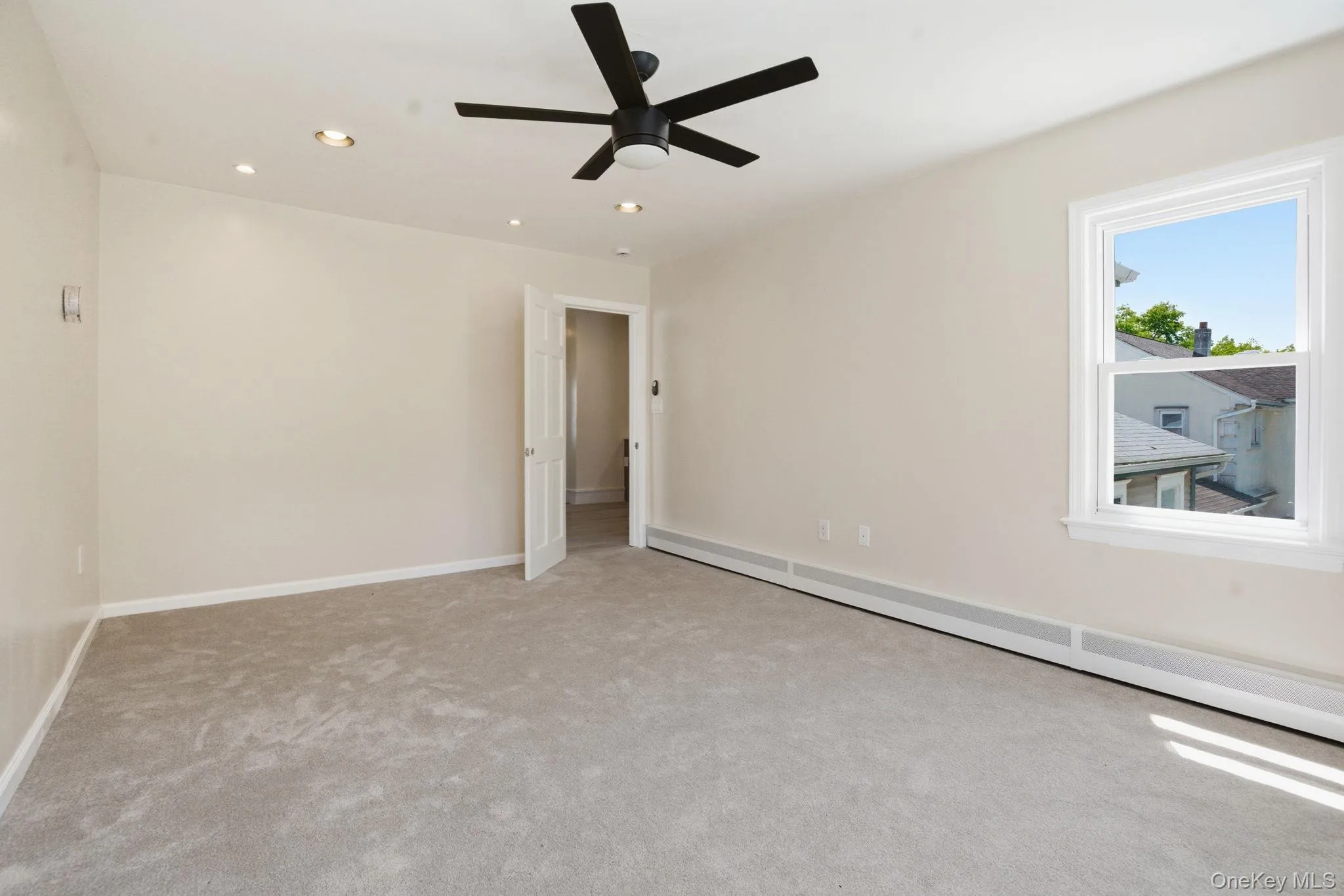 Spacious interior featuring neutral carpeting and light-toned walls Spacious interior featuring neutral carpeting and light-toned walls