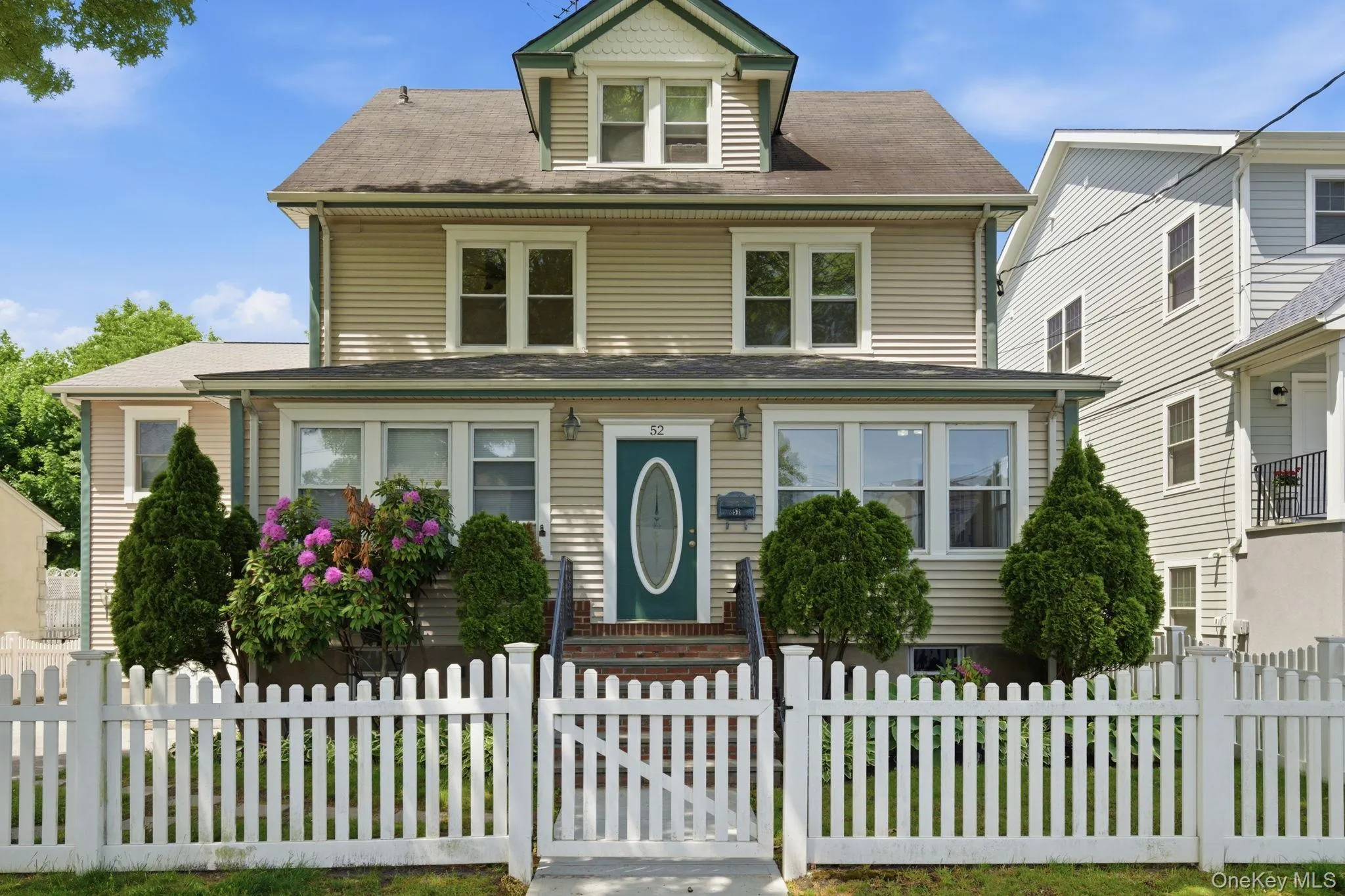 Two-story home with horizontal siding and a gambrel roofline Two-story home with horizontal siding and a gambrel roofline
