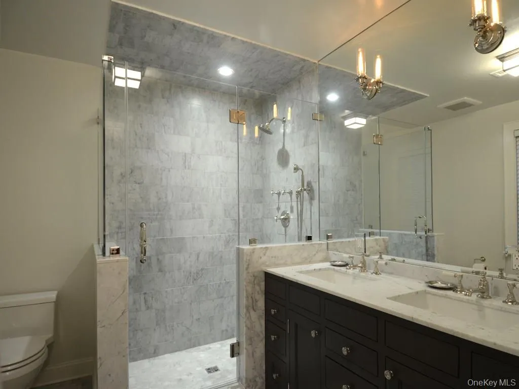 Primary bath with double sinks and radiant heat floor Primary bath with double sinks and radiant heat floor