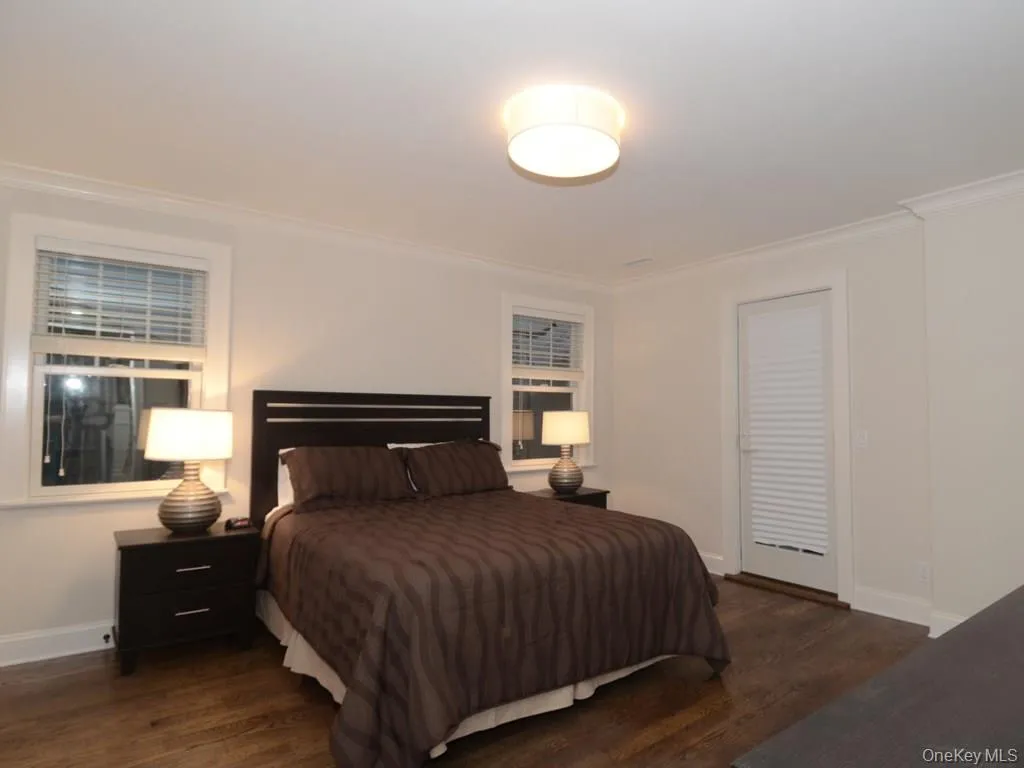 Primary bedroom with door on right to private deck. Double closets on left not shown. Primary bedroom with door on right to private deck. Double closets on left not shown.