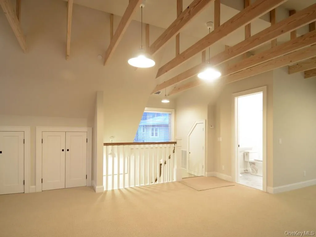 View of third floor with storage, staircase down and the bath. View of third floor with storage, staircase down and the bath.