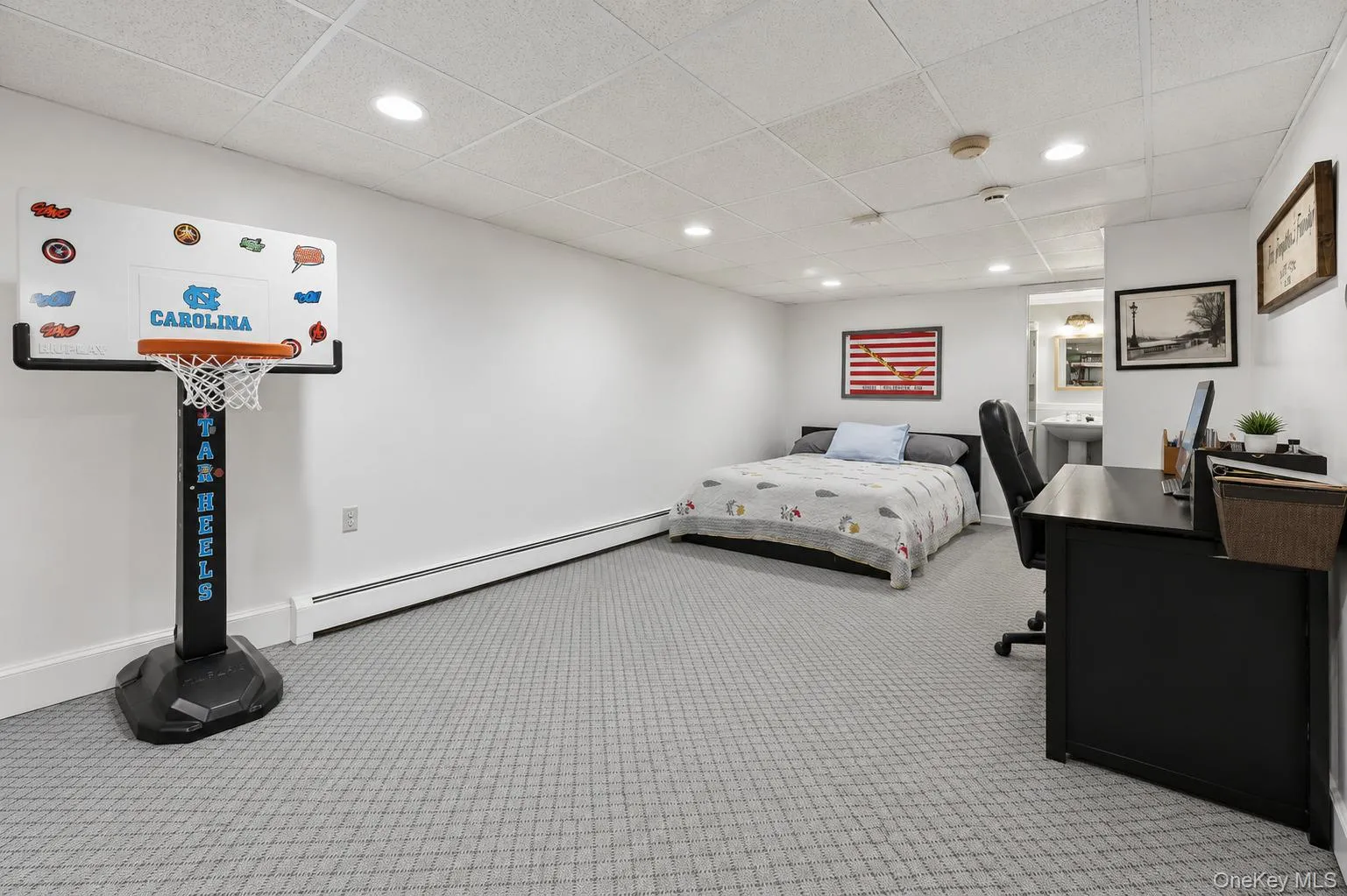 Open-concept room featuring white walls, gray patterned carpeting, and recessed lighting Open-concept room featuring white walls, gray patterned carpeting, and recessed lighting