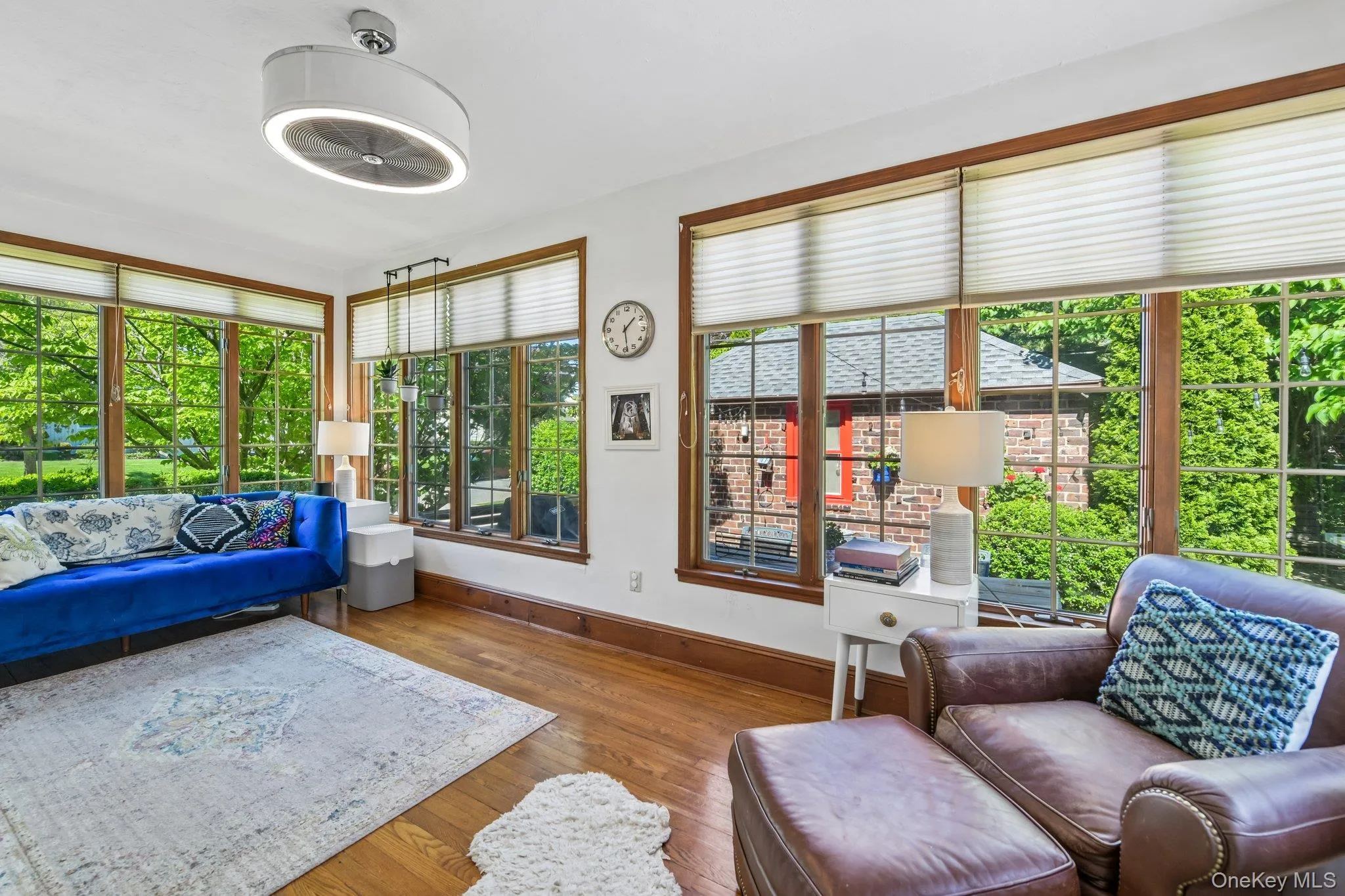 Hardwood flooring extends throughout this room, featuring ample natural light from multiple windows Hardwood flooring extends throughout this room, featuring ample natural light from multiple windows