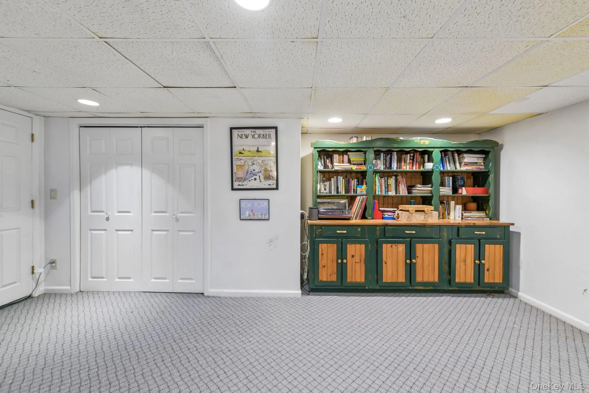 Open-concept room featuring white walls, gray patterned carpeting, and recessed lighting Open-concept room featuring white walls, gray patterned carpeting, and recessed lighting